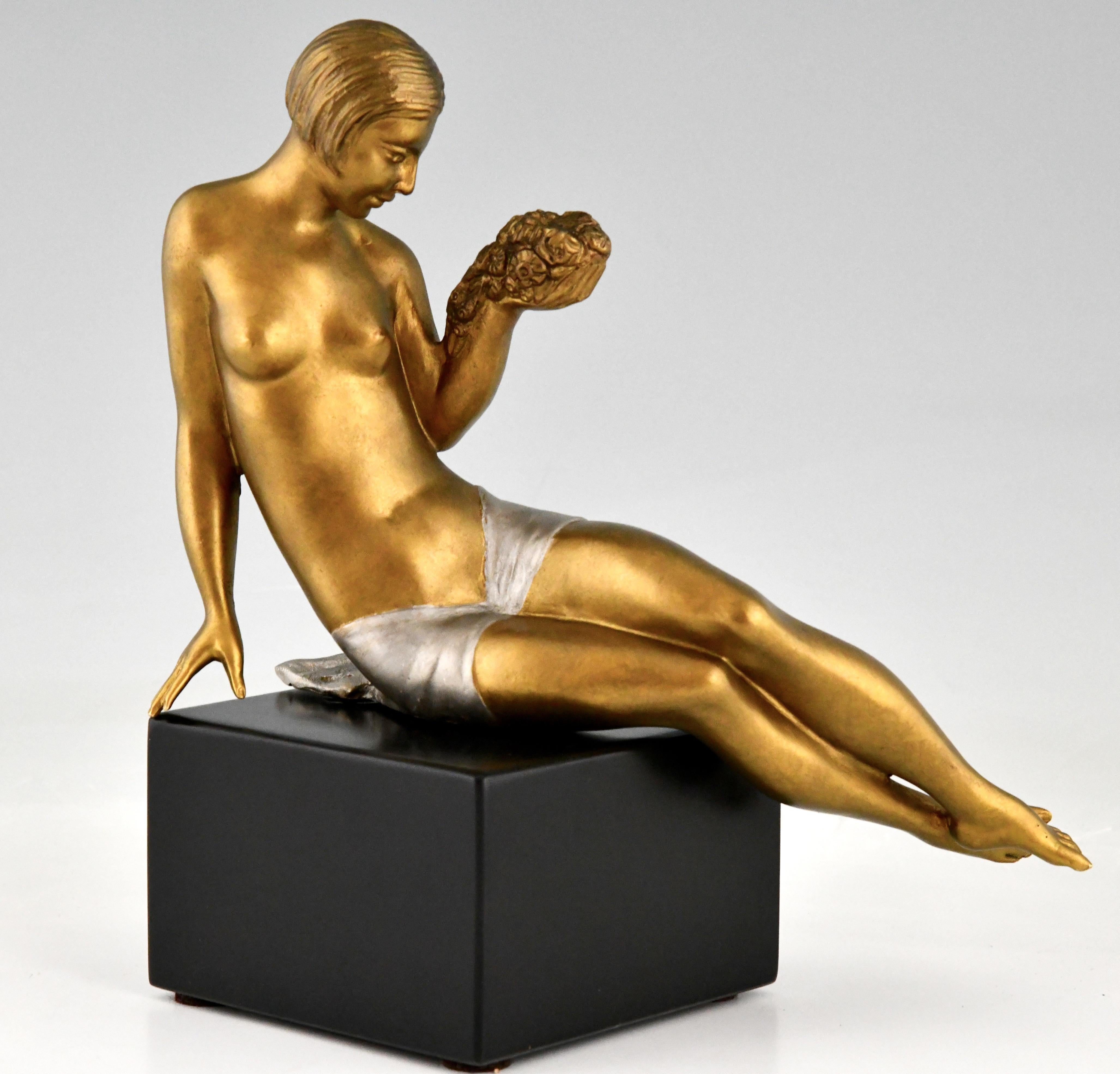 Art Deco bronze sculpture seated nude with flowers by Joseph Gauthier
Patinated bronze on a black marble base.
France 1930. 

Dictionnaire des peintres, sculpteurs, dessinateurs et graveurs, E. Benezit. Gründ 
The dictionary of sculptors in