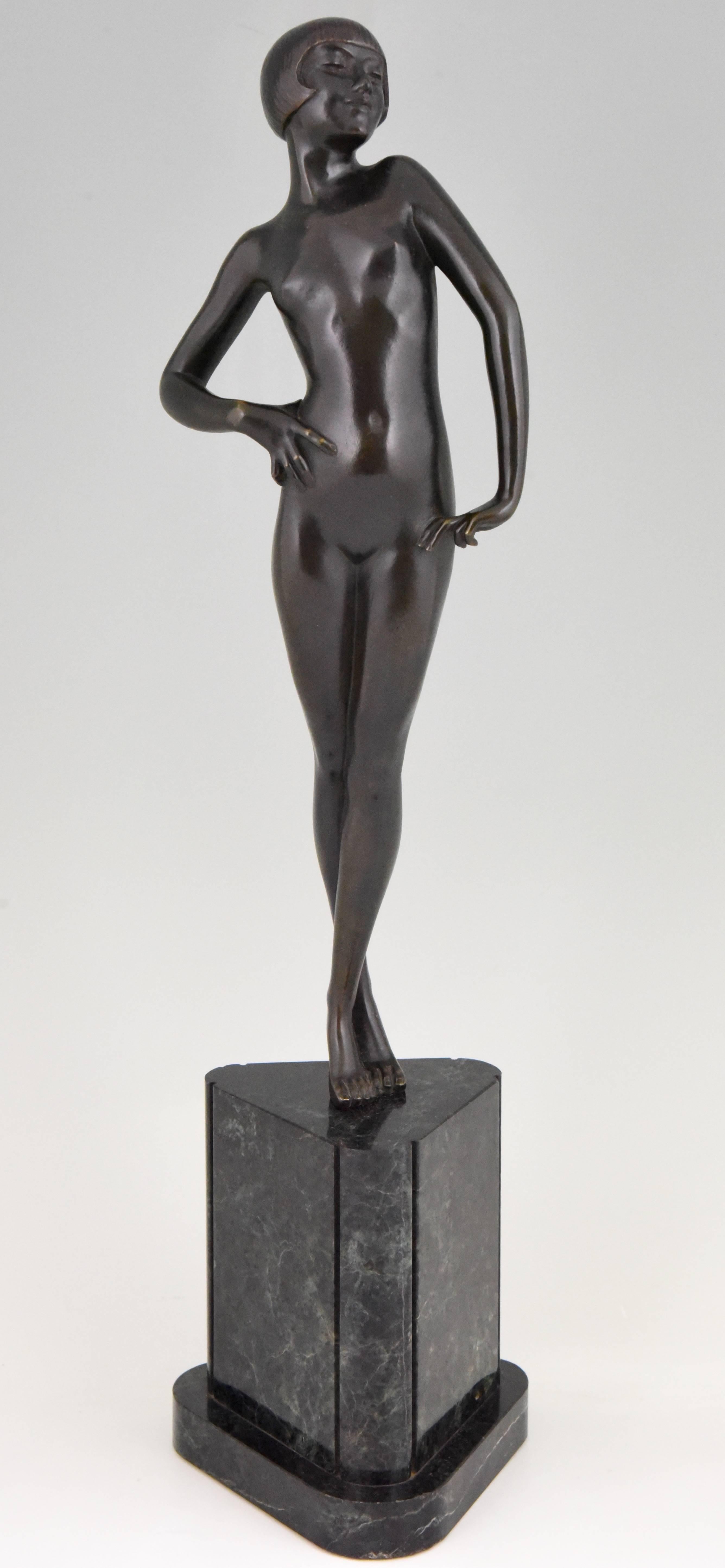 Pride, a very elegant and hard to find Art Deco bronze sculpture of a standing female nude by the French artist Philippe Devriez. This bronze has a beautiful patina and stands on a tringular marble base, France circa 1925 and is illustrated in “Art