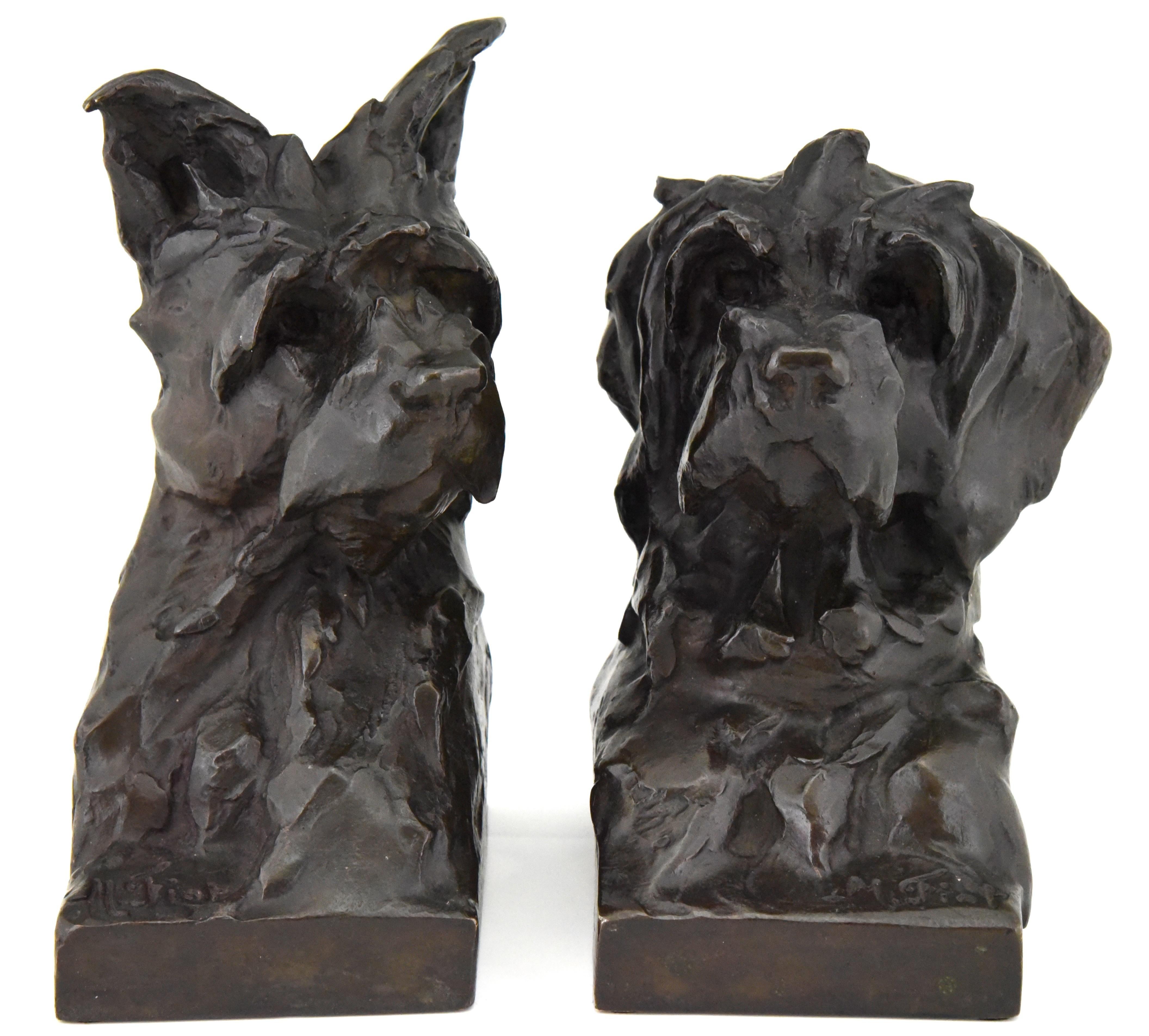 Pair of bronze bookends in the shape of terrier dog heads by the French artist Maximilien Louis Fiot, 1886-1953. 
The sculptures have a beautiful patina and are signed by the artist as well as by the founder, Susse Freres. The dog busts are cast in