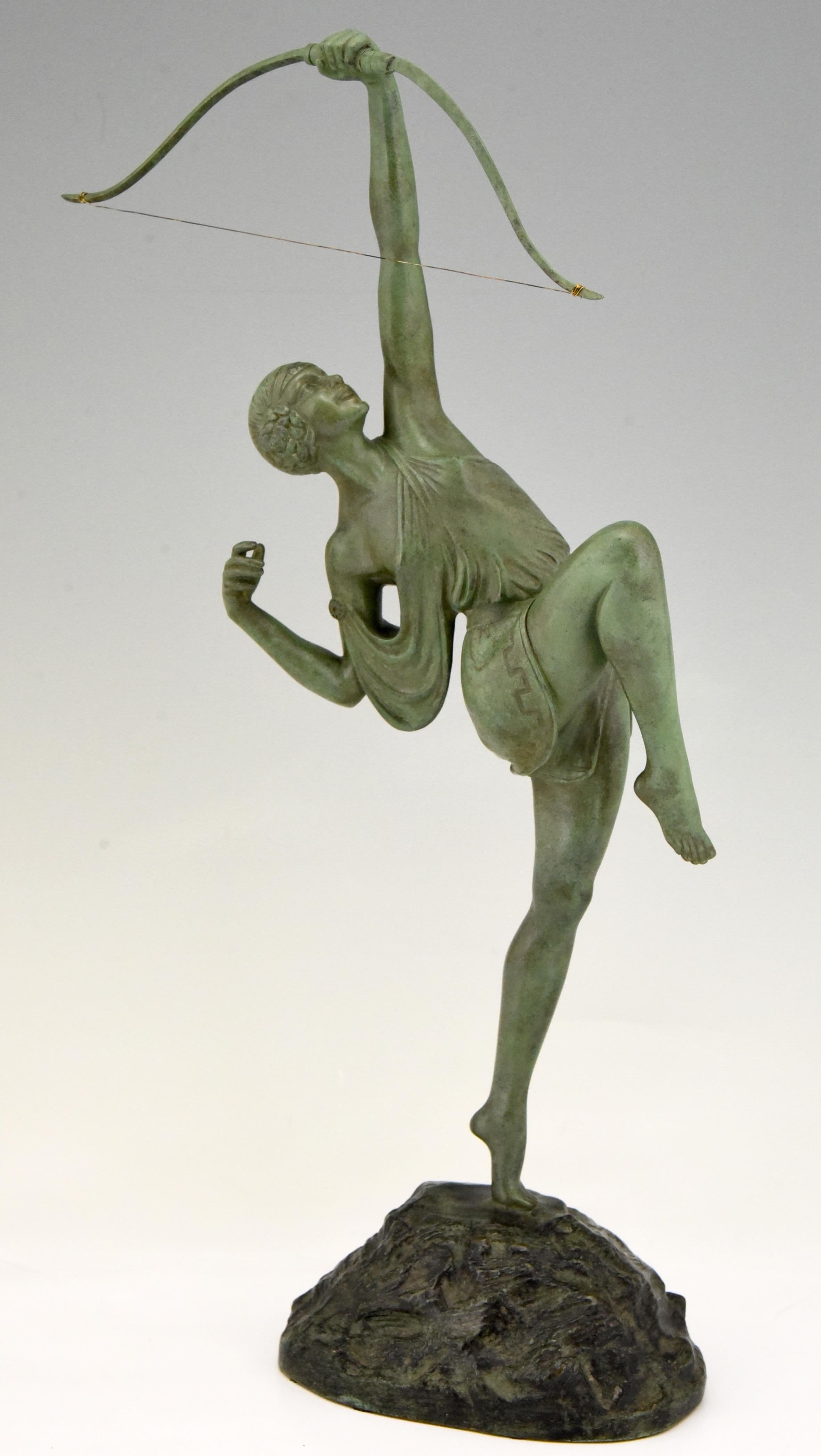 Art Deco bronze of a woman archer, Diana with bow by the famous French artist Pierre Le Faguays, the bronze is signed on the base and bears the Susse Frères foundry seal as well as the founders' signature, France, 1925. The sculpture has a green
