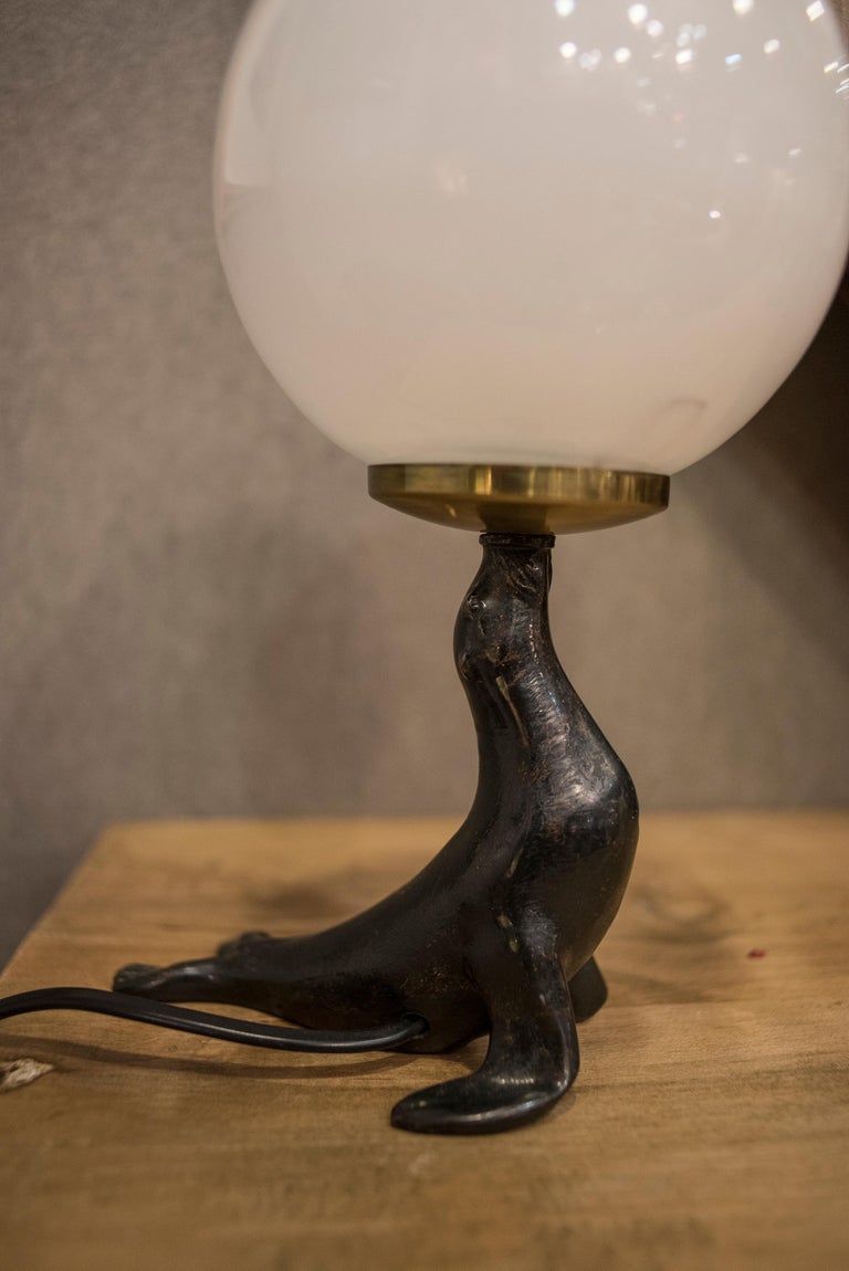 Art Deco Bronze Seal Figure and Glass Globe Table Lamp at 1stDibs