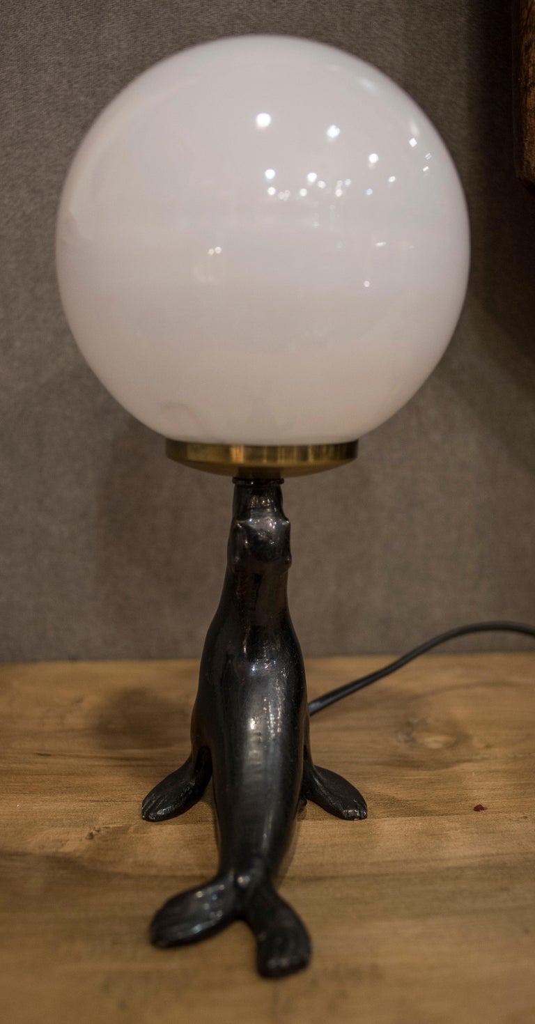 Art Deco Bronze Seal Figure and Glass Globe Table Lamp at 1stDibs