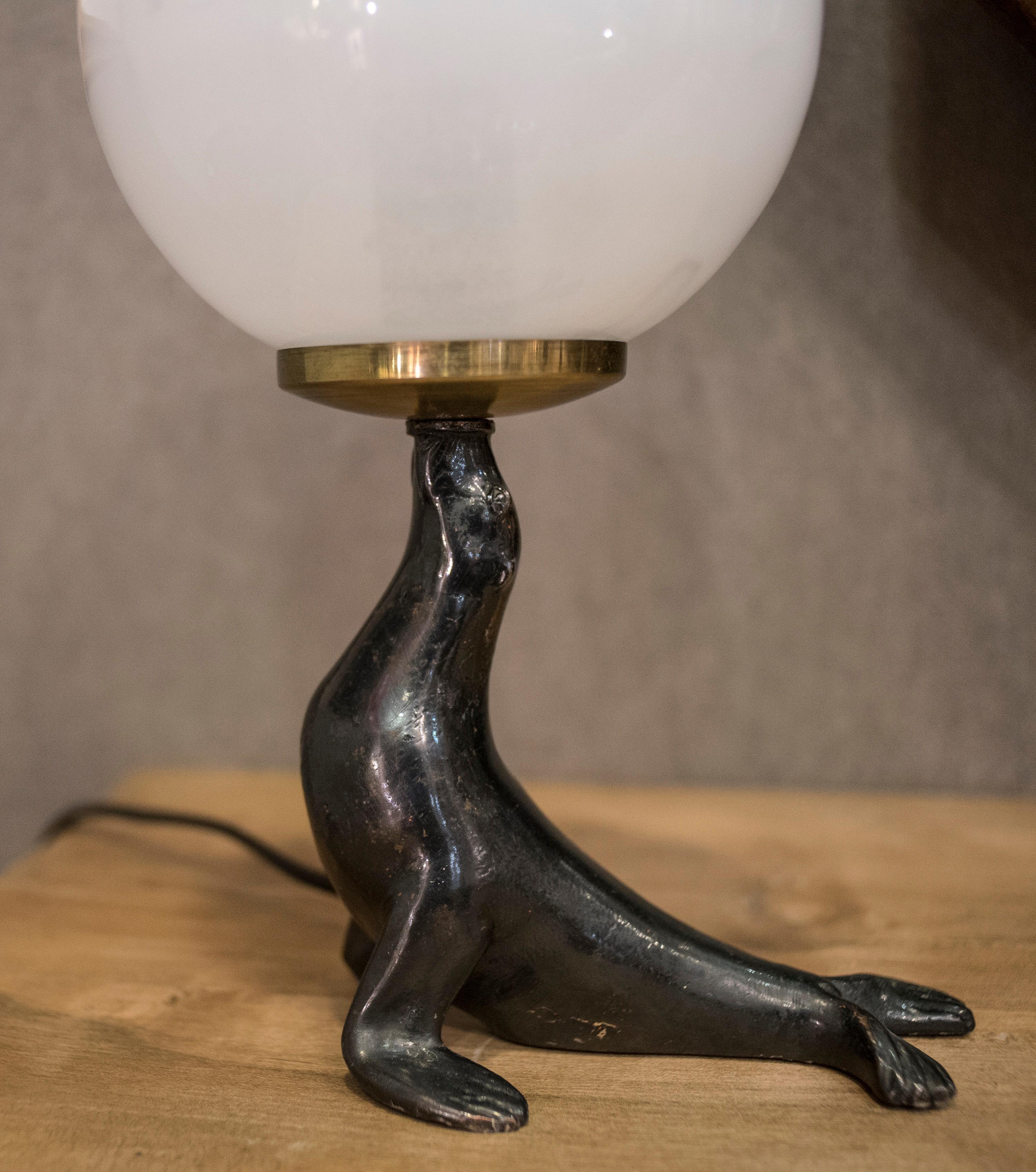 Mid-20th Century Art Deco Bronze Seal Figure and Glass Globe Table Lamp 