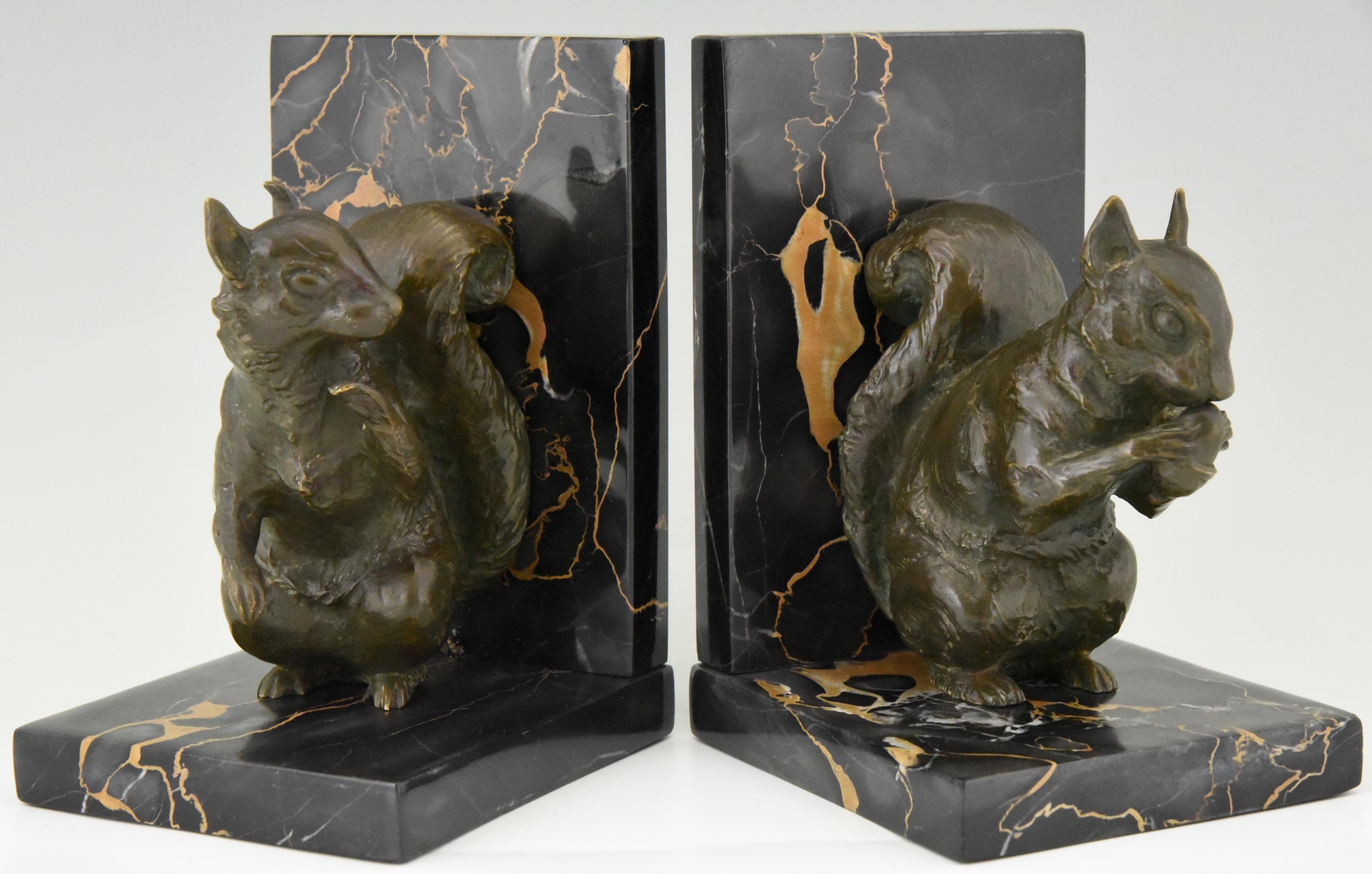 Pair of Art Deco bronze bookends modelled as two squirrels by the French artist René Papa. The bronzes have a lovely green patina and are mounted on fine Portor marble bases, circa 1930.

      