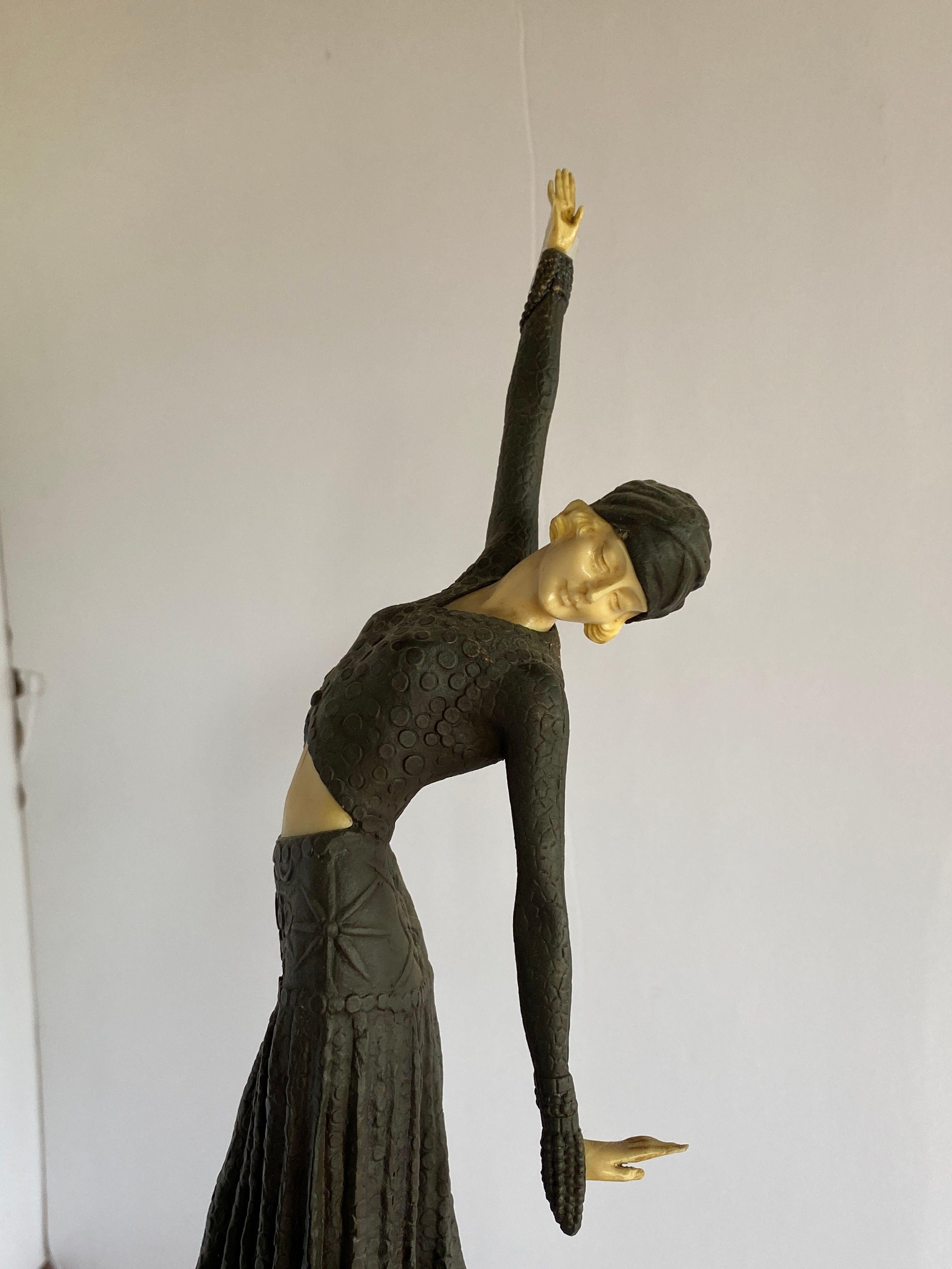Vintage Art Deco bronze statue featuring a flapper dancer fashioned after Chiparus with a bronze body and bone face, feet, and hands. The statue stands on a large stepped abase made from multi-colored marble.

Circa 1920.