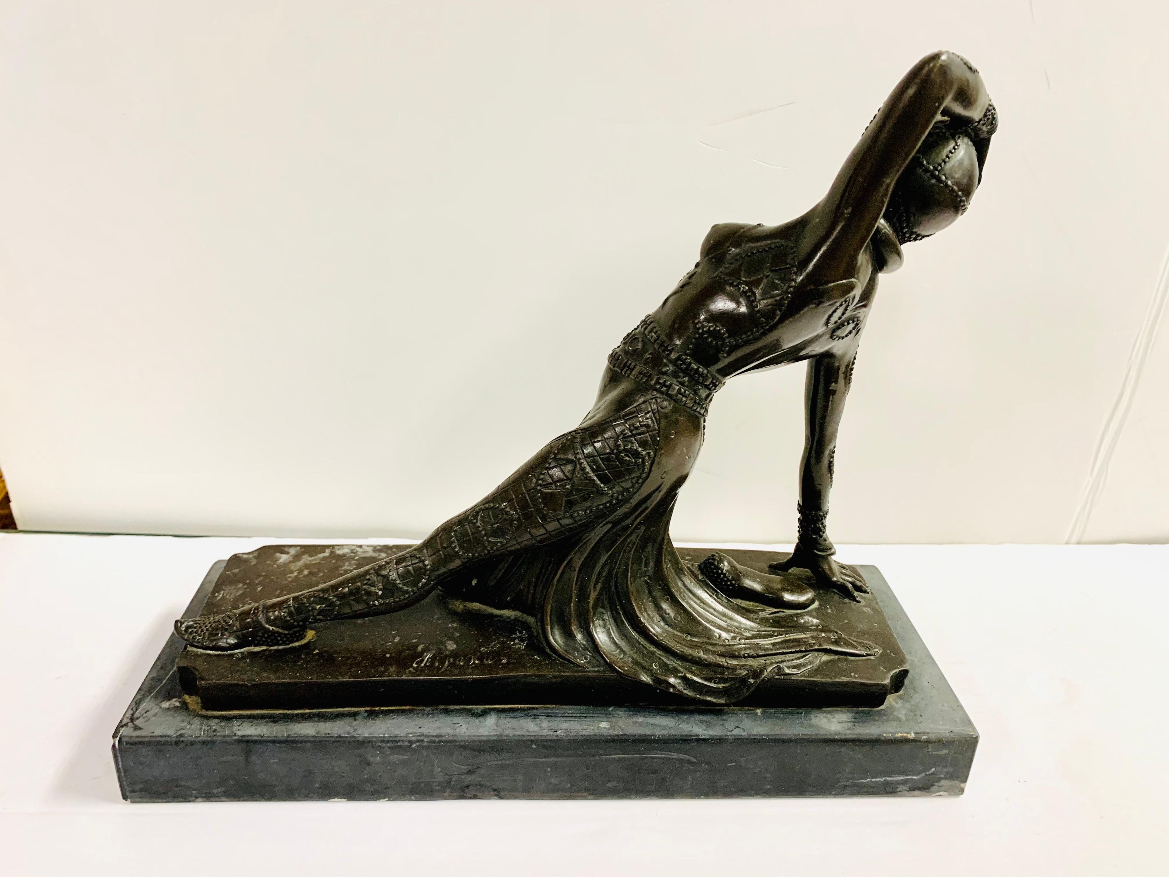 Bronze statue depicts a flapper girl with her breasts fully exposed as she is in a semi reclining dance position. The statue is not signed , circa 1930’s.