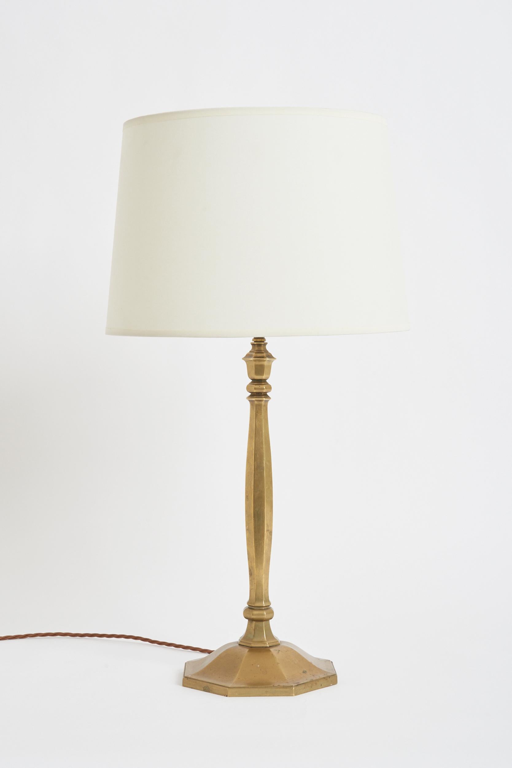 An Art Deco bronze table lamp
France, circa 1920
With the shade: 66 cm high by 35.5 cm diameter
Lamp base only: 47 cm high by 19 cm diameter.