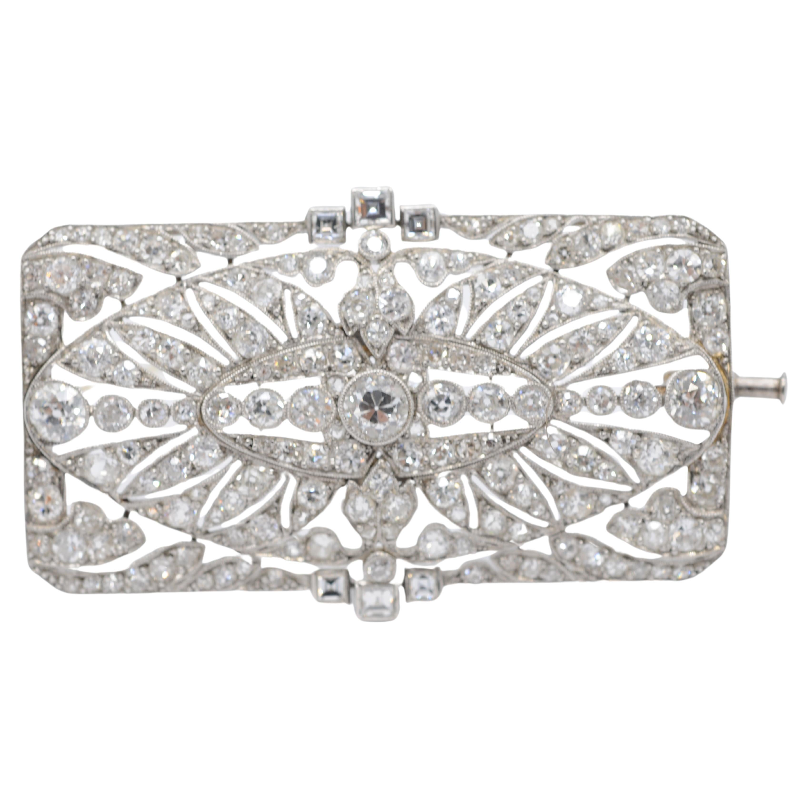 Introducing a stunning Art Deco brooch crafted from platinum. This exquisite piece exudes intricate elegance, capturing the essence of the Art Deco era with its delicate design and dazzling diamonds. Each diamond, expertly cut in the old European