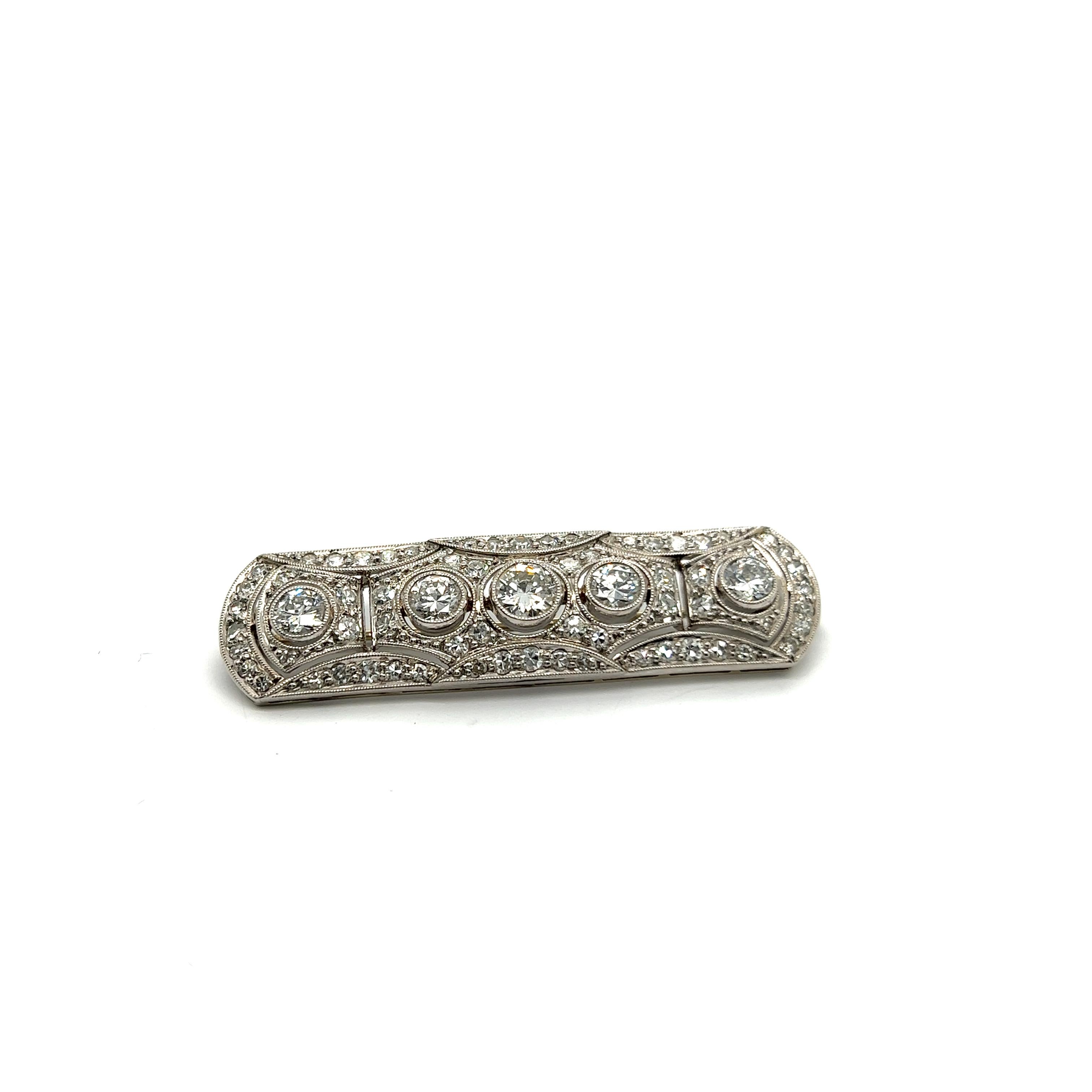 The epitome of elegance, this Art Deco Brooch with diamonds is an exquisite masterpiece that captivates with its sophistication. Crafted in lustrous platinum and gold, it sparkles with a constellation of old-cut diamonds totaling 2.29 carats. The