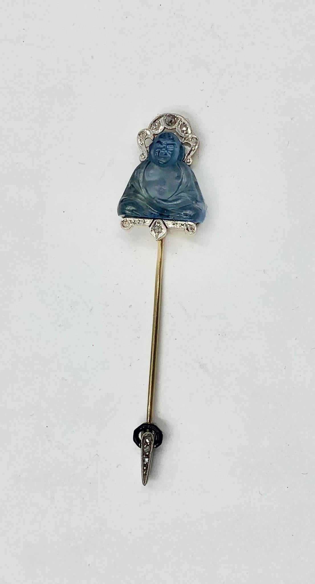 The Rose Diamond Platinum Enamel Buddha Jabot Pin Brooch is an Art Deco Masterpiece.  The seated Buddha is blue art glass and is absolutely exquisite.  Buddha wears a Rose Cut Diamond and Platinum Headdress.  Below the seated Buddha is a further
