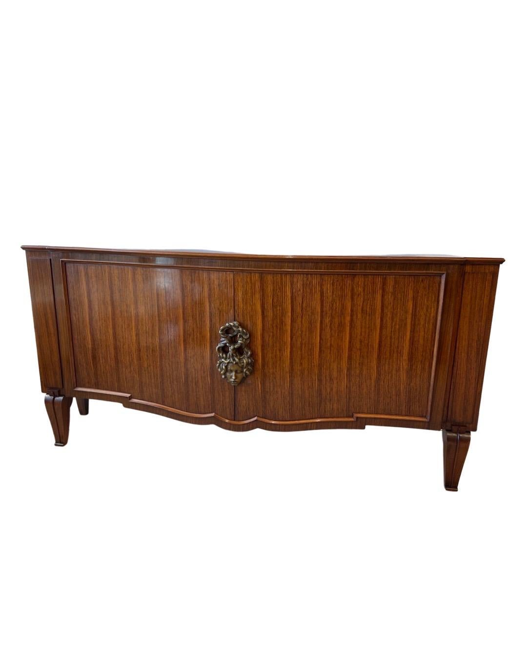 This Art Deco 2-door buffet/cabinet with cleaned designed lines was constructed in 1937 by Andre Arbus in solid Rosewood with a signed Androussov's Bronze Medalion lock of 