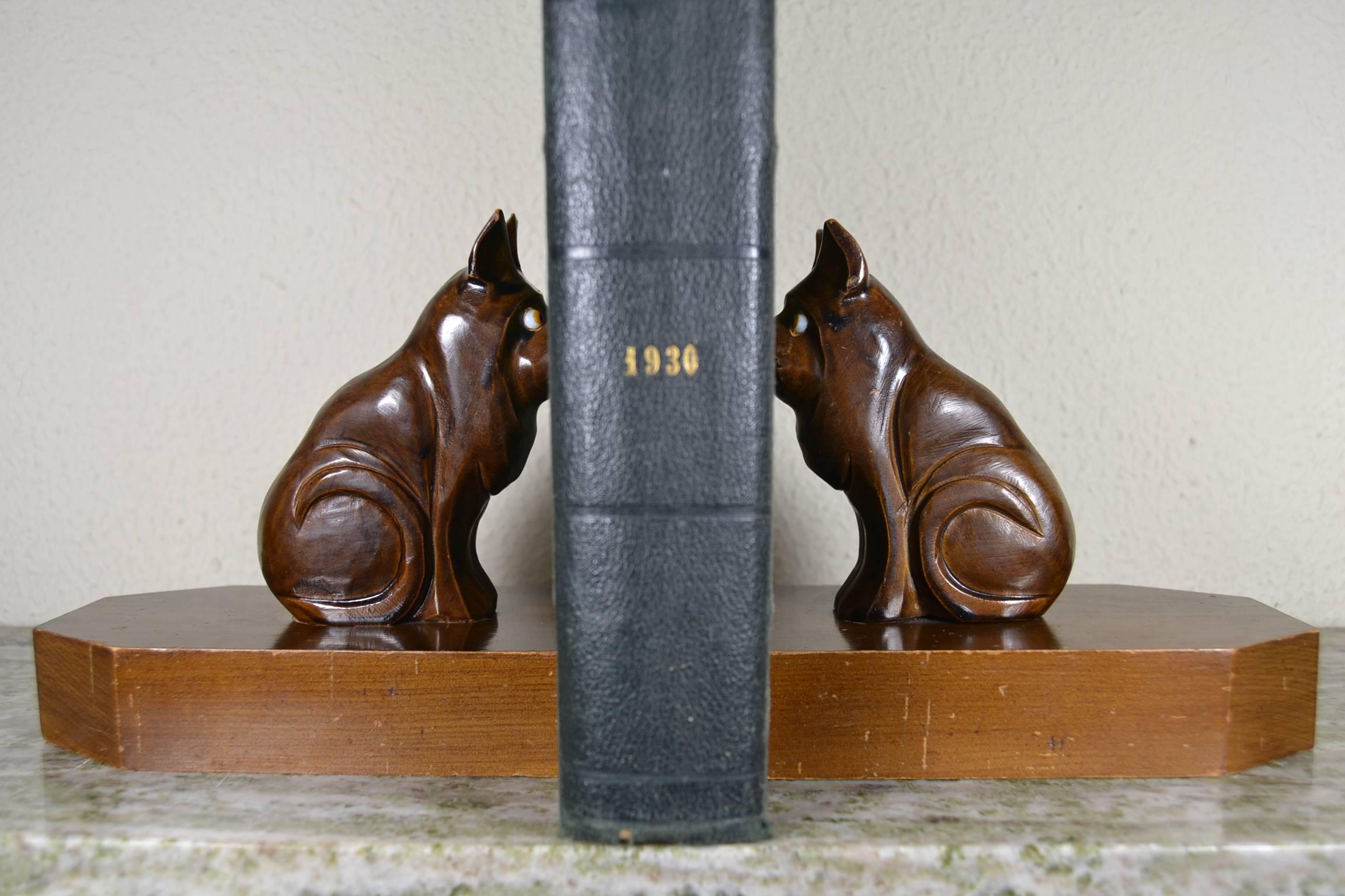 Hand carved wooden bookends with bulldog dogs and glass eyes. 
These Art Deco bookends dates circa 1930. 
Wood Bulldogs mounted on wood bases. 

Dimension given below is the size of 1 bookend.
 