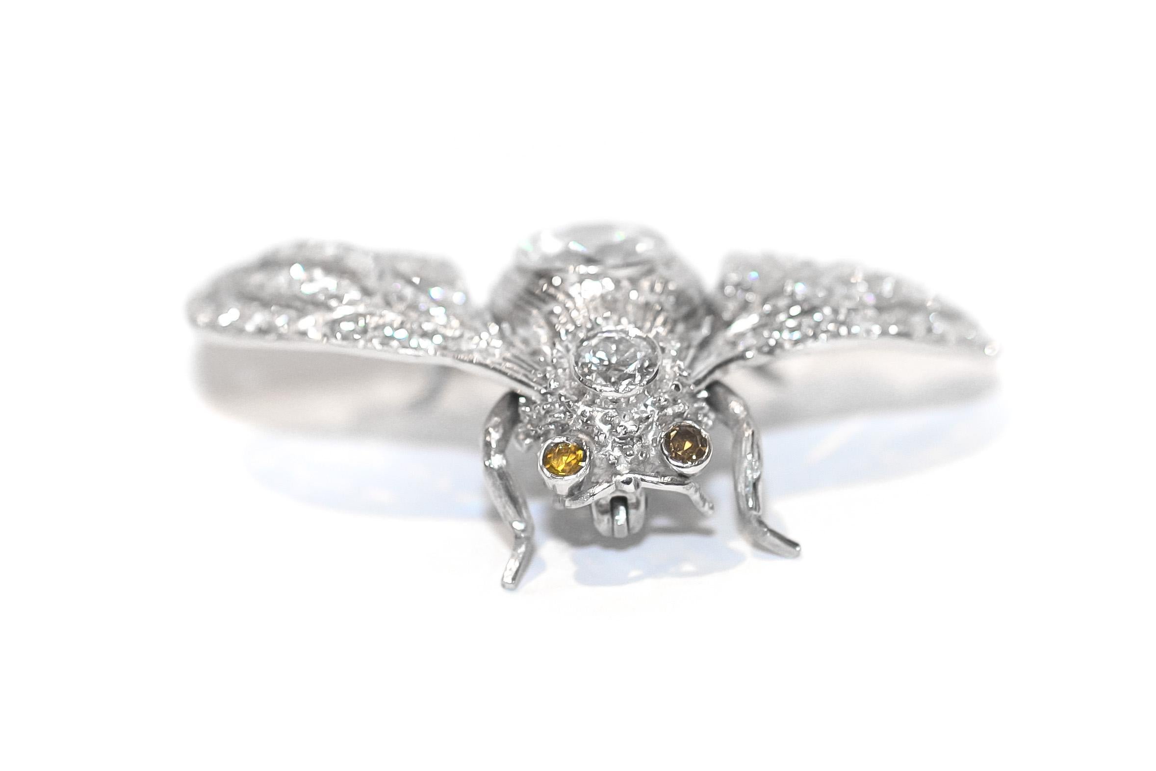 Art Deco style Bumble Bee Brooch crafted in Platinum with Round Brilliant weighing 1.25 carats in the center, accented with round old-cut diamonds. 