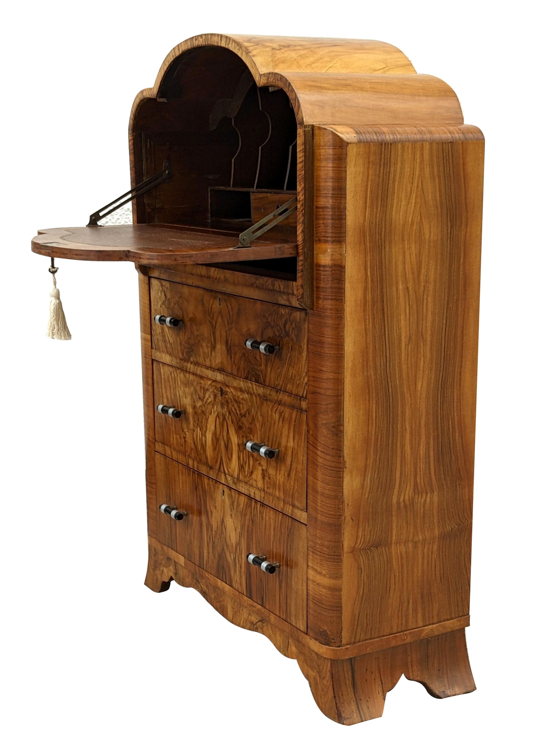 This is a fantastic 1930s Art Deco writing bureau of small proportions, a really superb piece of furniture. Veneered in a lovely figured walnut 'Flame Grain' with three drawers to the base and a pull down top reveals a desk area with slots for