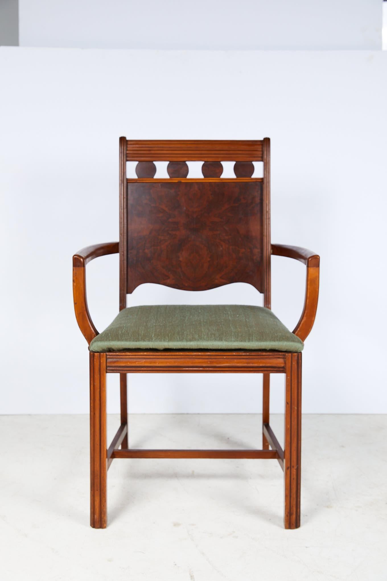 Early 20th century Art Deco period side chair with a reeded top chair rail and uprights framing four burl walnut veneered discs over an inset burl walnut back panel having a serpentine bottom edge. Bowed arms gracefully terminate into an upholstered