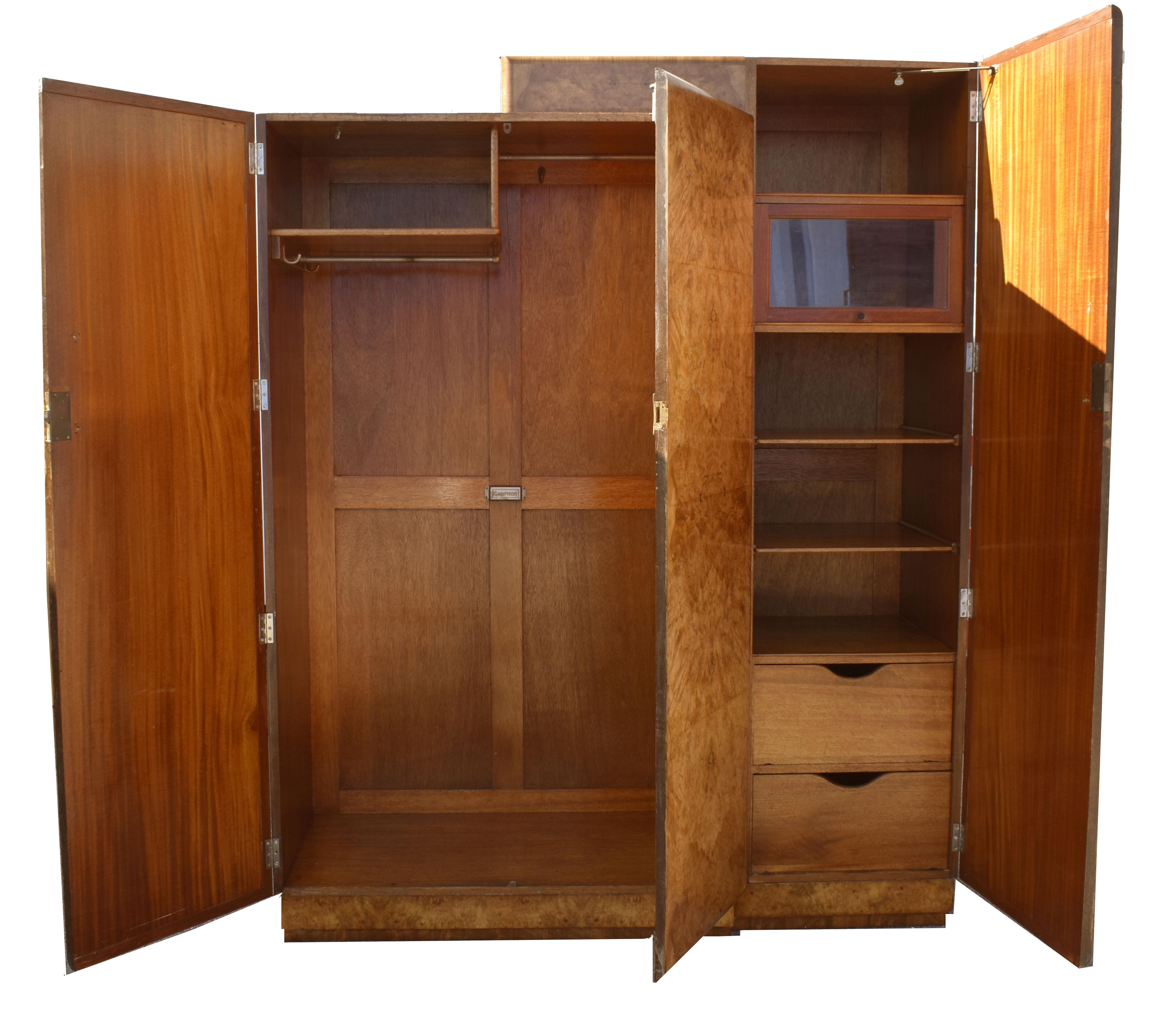 For your consideration is this superbly styled and original Art Deco heavily figured Walnut wardrobe. Dating to the 1930's this wardrobe features fully book paged honey toned walnut veneered doors. Original solid walnut bar handles with chrome