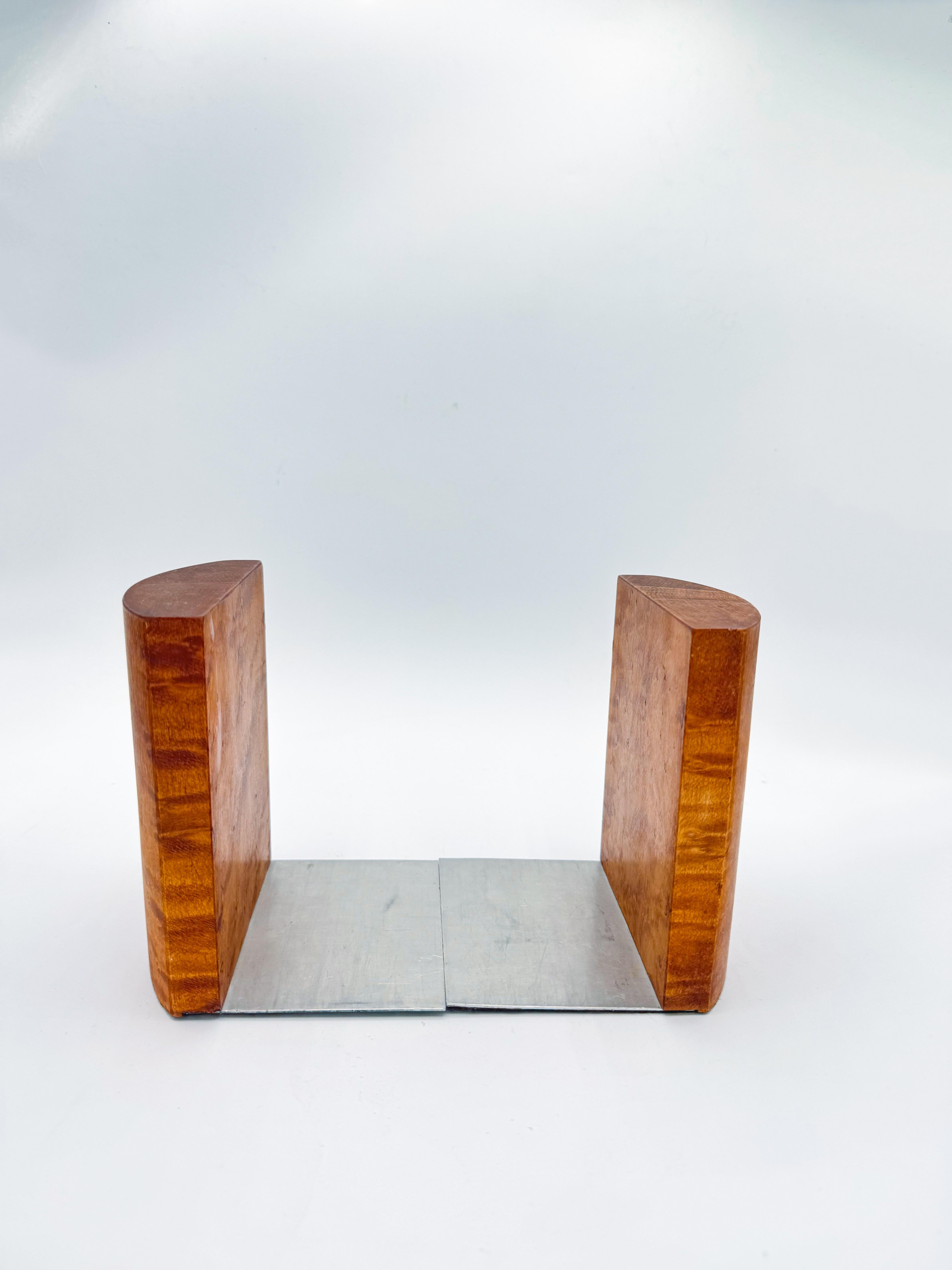 Beautifully crafted, this striking pair of Art Deco bookends showcases the natural beauty and character of burl wood. Their sculptural, rounded form and rich wood grain pattern bring warmth, texture, and sophistication to any space. Though they show