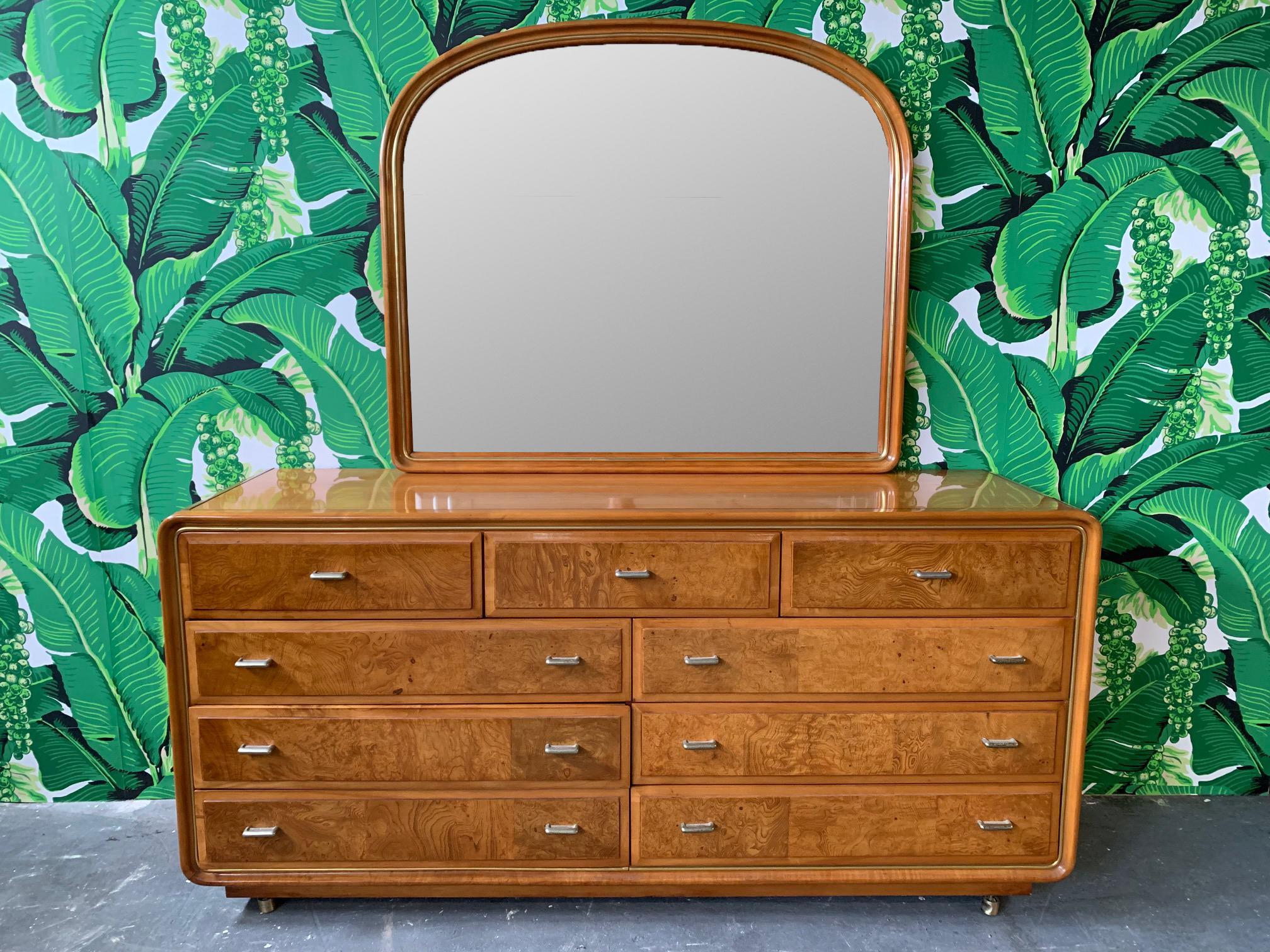 Art Deco style dresser by American of Martinsville features burl wood drawer faces, brass hardware and matching mirror with routed detailing. In beautiful vintage condition with only very minor signs of use consistent with age. Dresser measures: 68