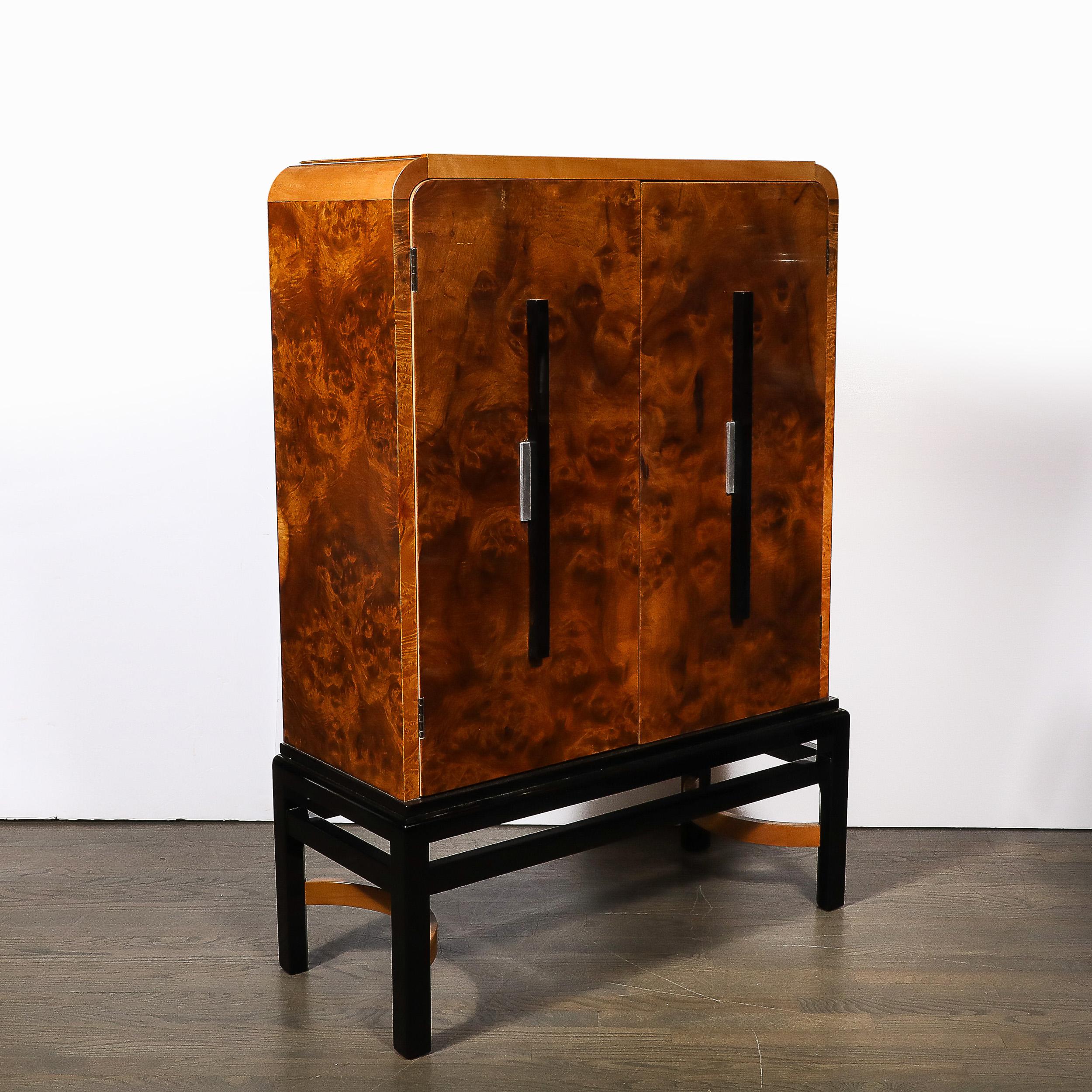 This exquisite and thoughtfully designed Art Deco Streamlined Machine Age Burled Walnut & Black Lacquer Bar Cabinet w/ Aluminum Pulls is by the esteemed designer Donald Deskey for the Hastings Company and originates from the Untied States, Circa