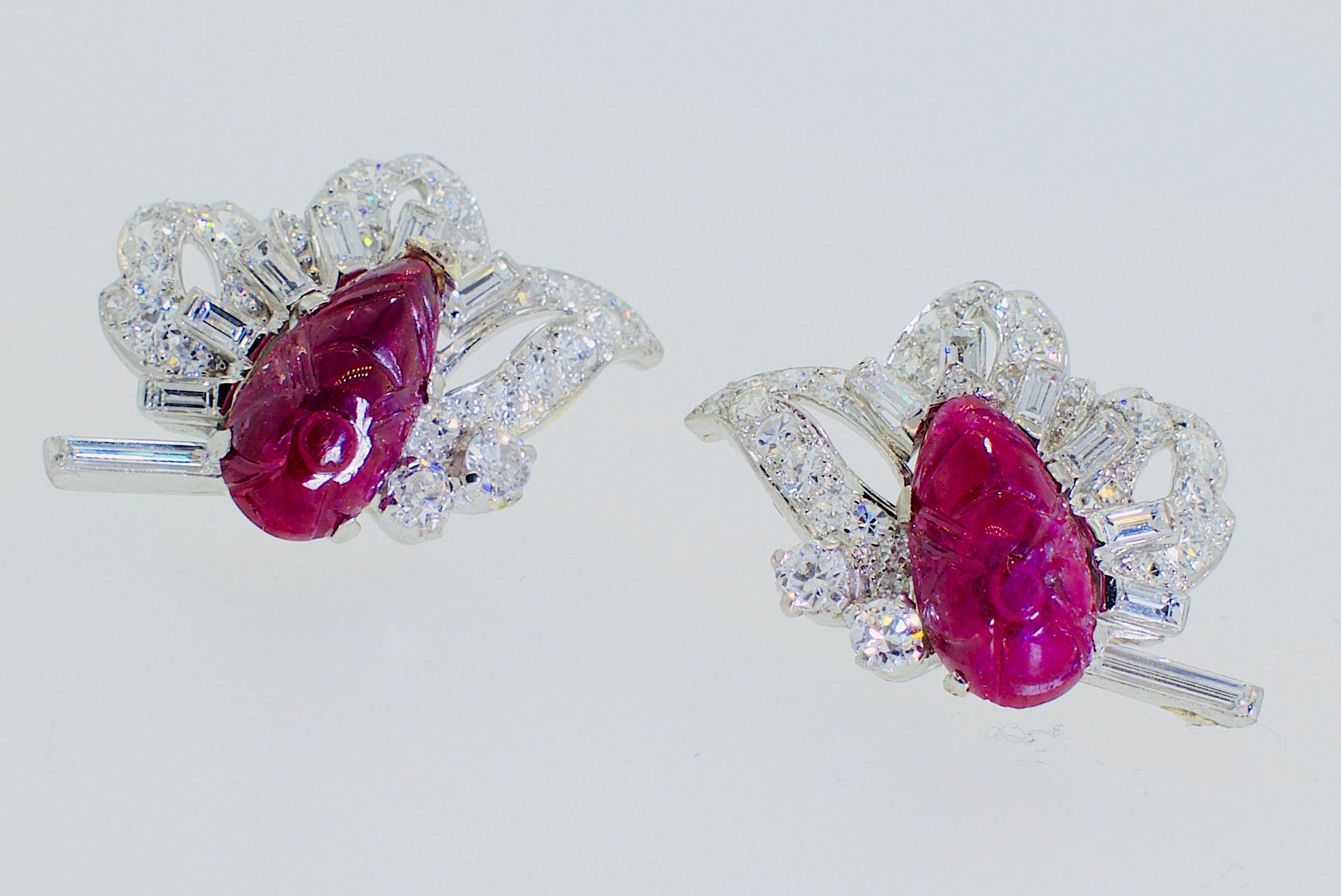 Art Deco Stylized Diamond and carved floral motif natural Ruby earrings, platinum center a carved natural ruby accented with fine white diamonds, both round and fancy cut baguette cut diamonds, the stem of the flower is one long baguette cut diamond.