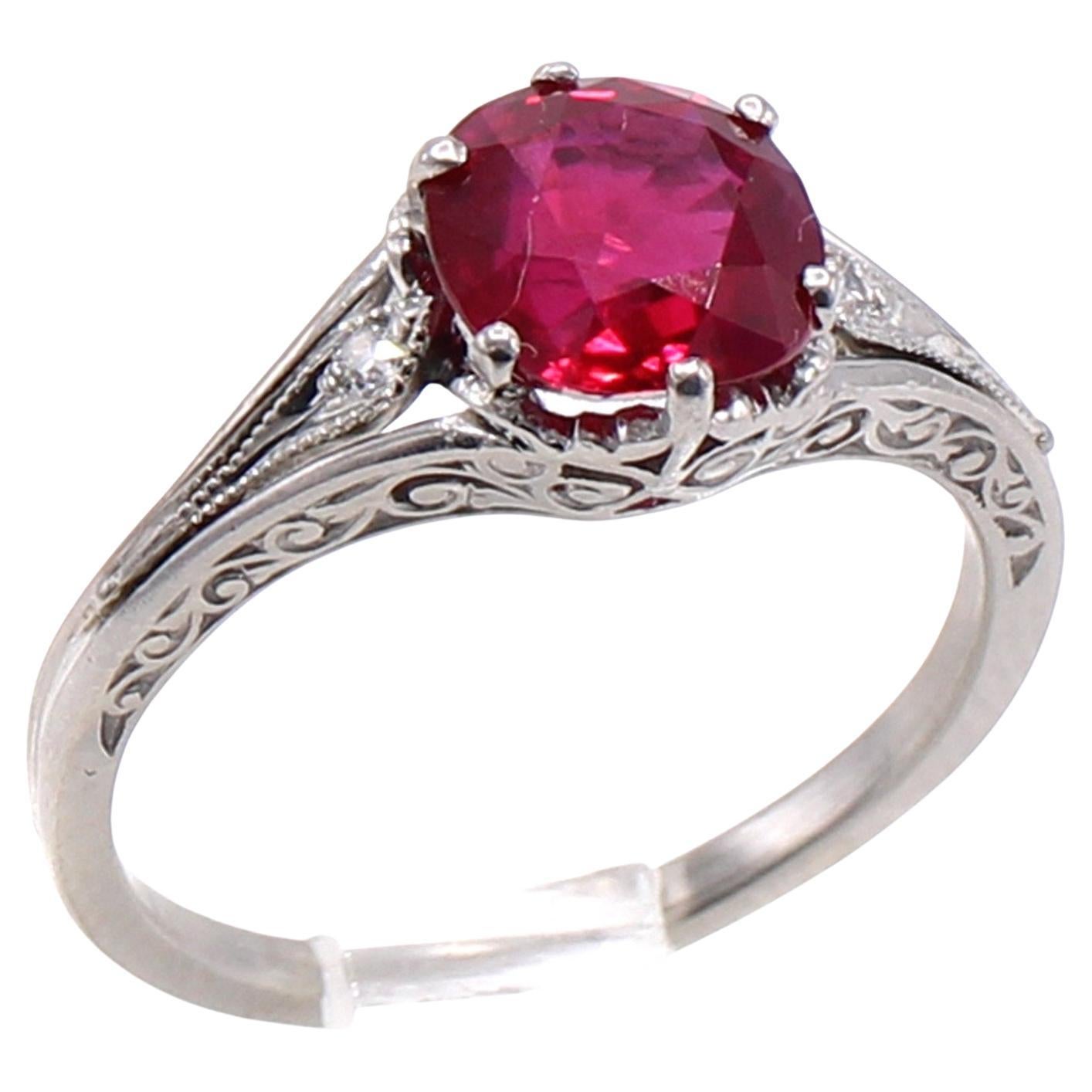 Art Deco platinum hand-made ring featuring a 1.70 carat Burma ruby. This pigeon blood red ruby has an amazing color saturation, brilliancy and clarity. The ruby is accompanied by a report from AGL stating the origin as Burma. The finely azured and