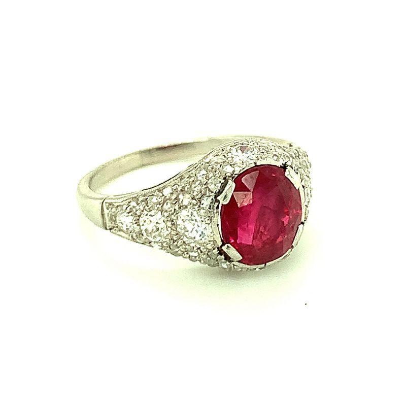 Art Deco vibrant ruby and diamond ring in platinum centering one oval brilliant cut ruby weighing 2.07 ct. with AGL certificate stating Burmese origin and no heat treatment. Ring is enhanced by fifty-two old Euro cut and single round cut