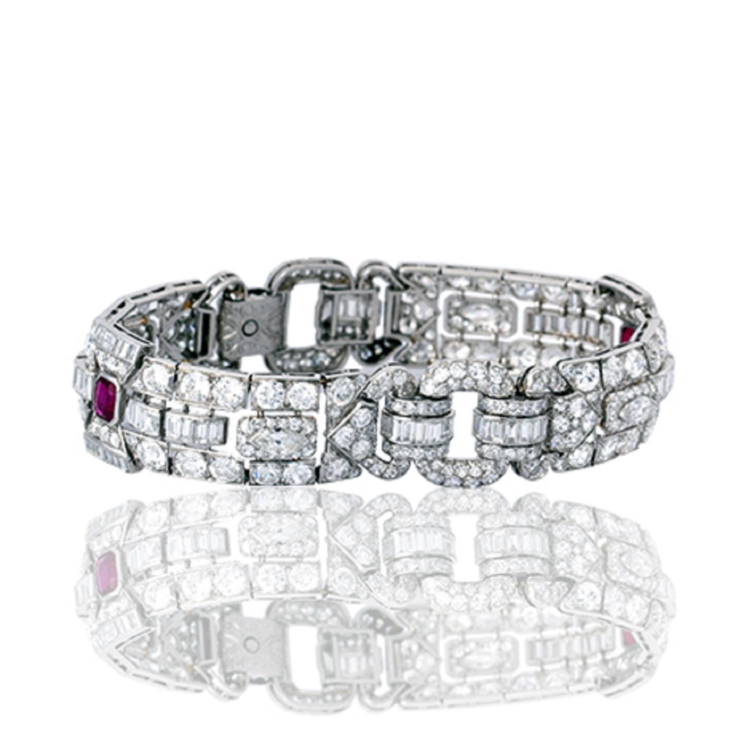Brilliant white Diamonds adorn the Art Deco Strap Bracelet. Two stunning and natural Burmese Rubies are placed among the geometrical and symmetrical links.

French Platinum hallmarks
24.0 ctw. F-H/SVVS2-SI round and baguette Diamonds
(2) 2.0 ctw.