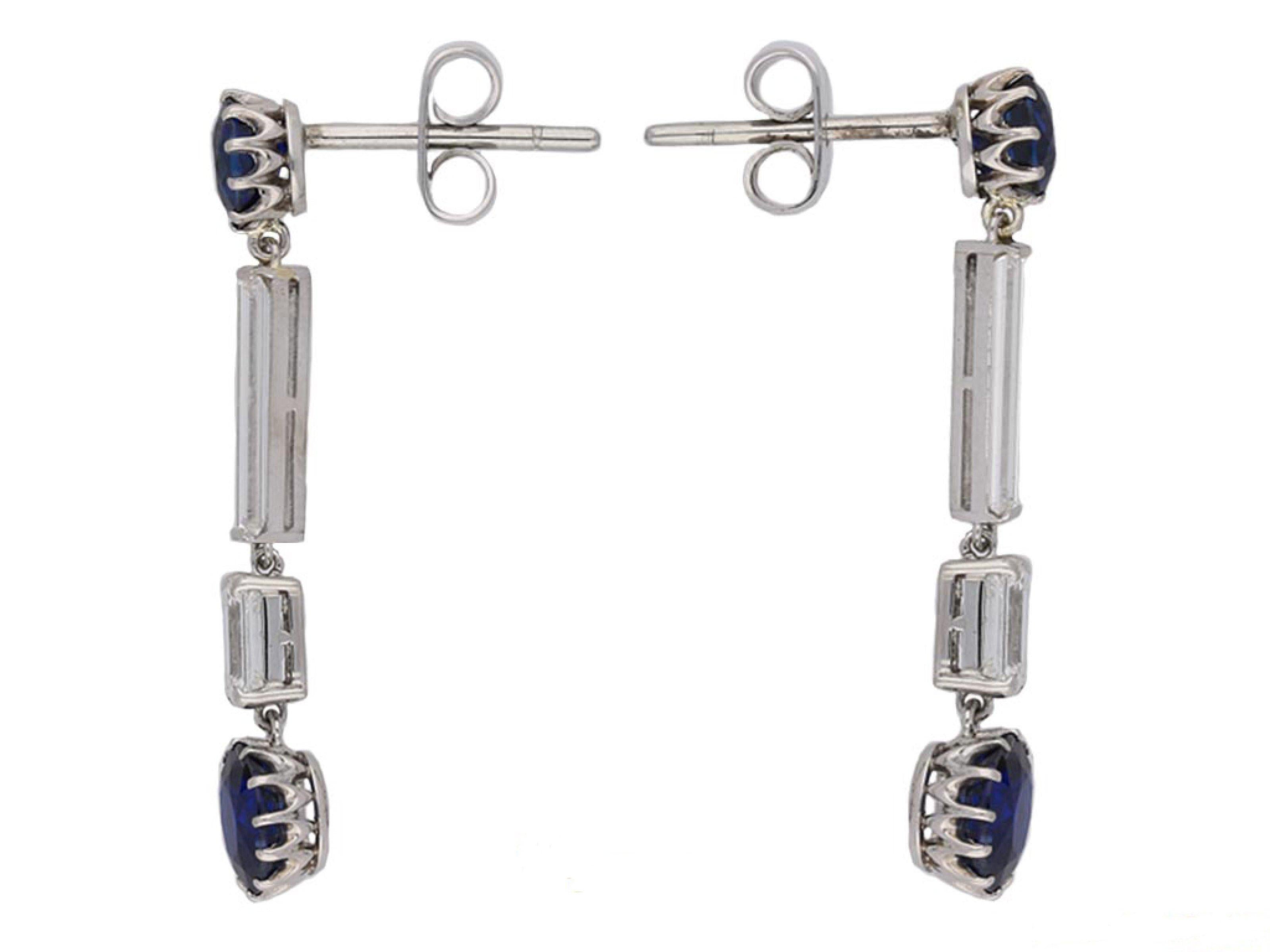 Art Deco Burmese sapphire and diamond drop earrings. A matching pair, each suspending a cushion shape old cut natural unenhanced Royal Blue Burmese sapphire in an open back claw setting, two in total with a combined weight of 1.80 carats, one fitted