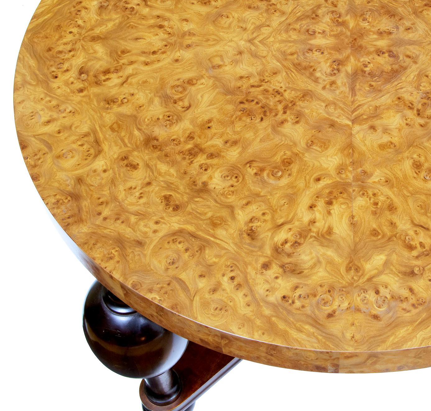 Art Deco burr elm coffee table circa 1930.

Thick circular top veneered in stunning burr elm quarter veneered so its in a repeating pattern. Standing on dark stained bulbous turned legs united by a x frame stretcher.

Minor surface marks.