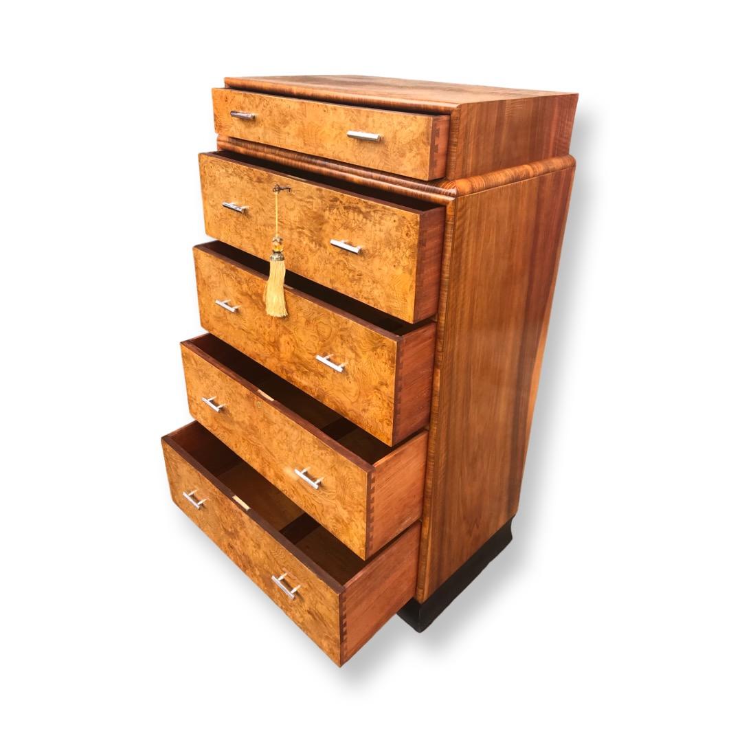 A beautiful Art Deco Burr Elm Art Deco Skyscraper Chest of drawers. This particular chest is veneered in the most gorgeous swirling honey coloured burr elm, the drawer fronts and the top also, making this extremely desireable as most other Chest of