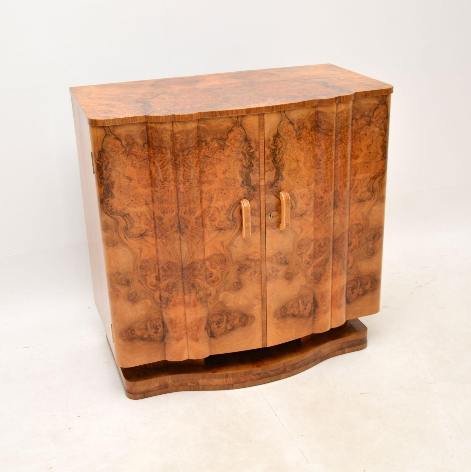 A stunning Art Deco burr walnut cabinet by Harry and Lou Epstein. This was made in England, it dates from the 1920-30’s.

It is of exceptional quality, with a lovely compact design and beautifully fitted interior. The burr walnut grain patterns and