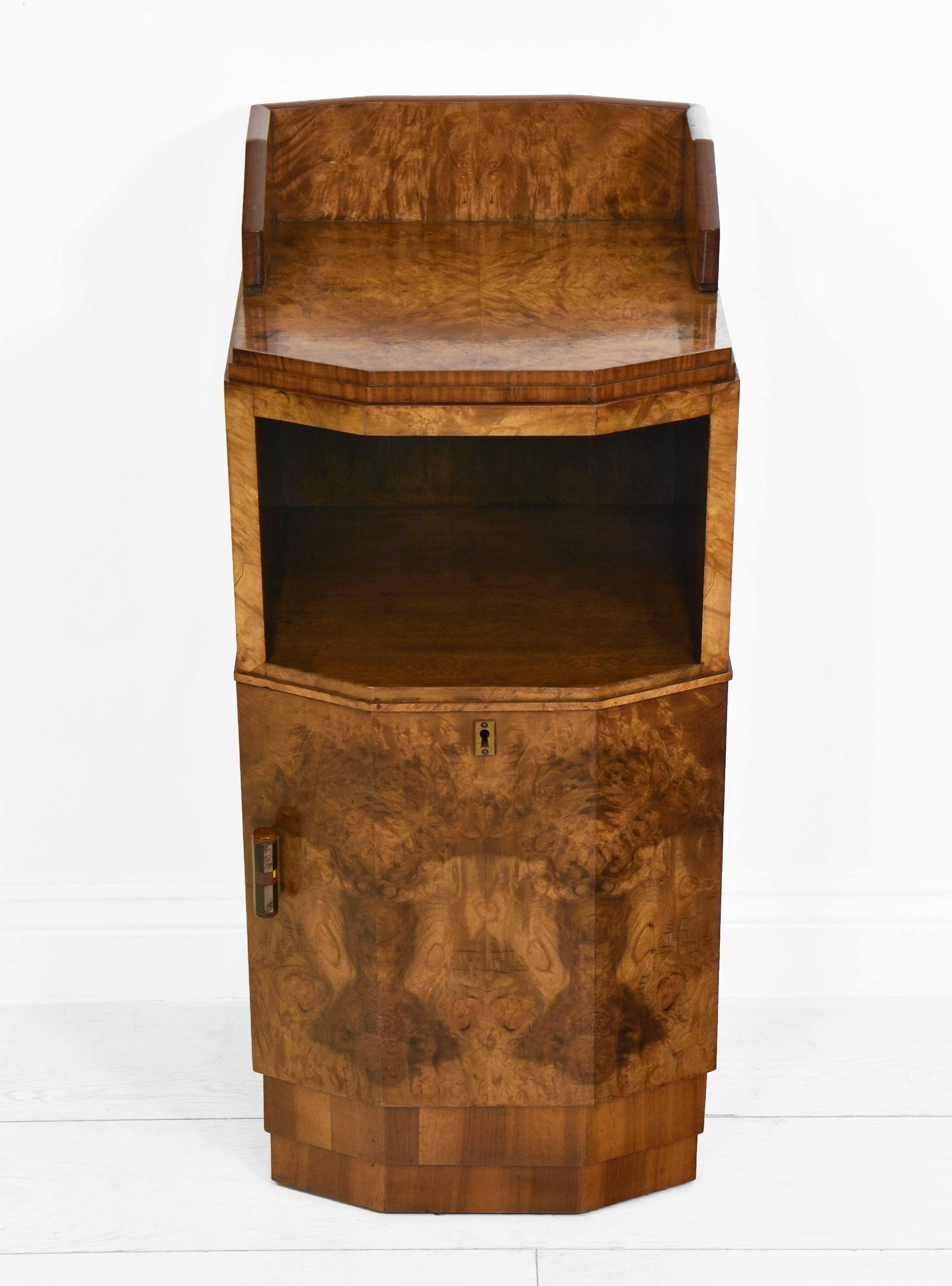 A stylish Art Deco burr and figured walnut canted bedside cabinet on stepped plinth. Circa 1930.

*Free delivery for all areas in mainland England & Wales only. Delivery to room of choice by a two person team. Items are left packed.

The cabinet is