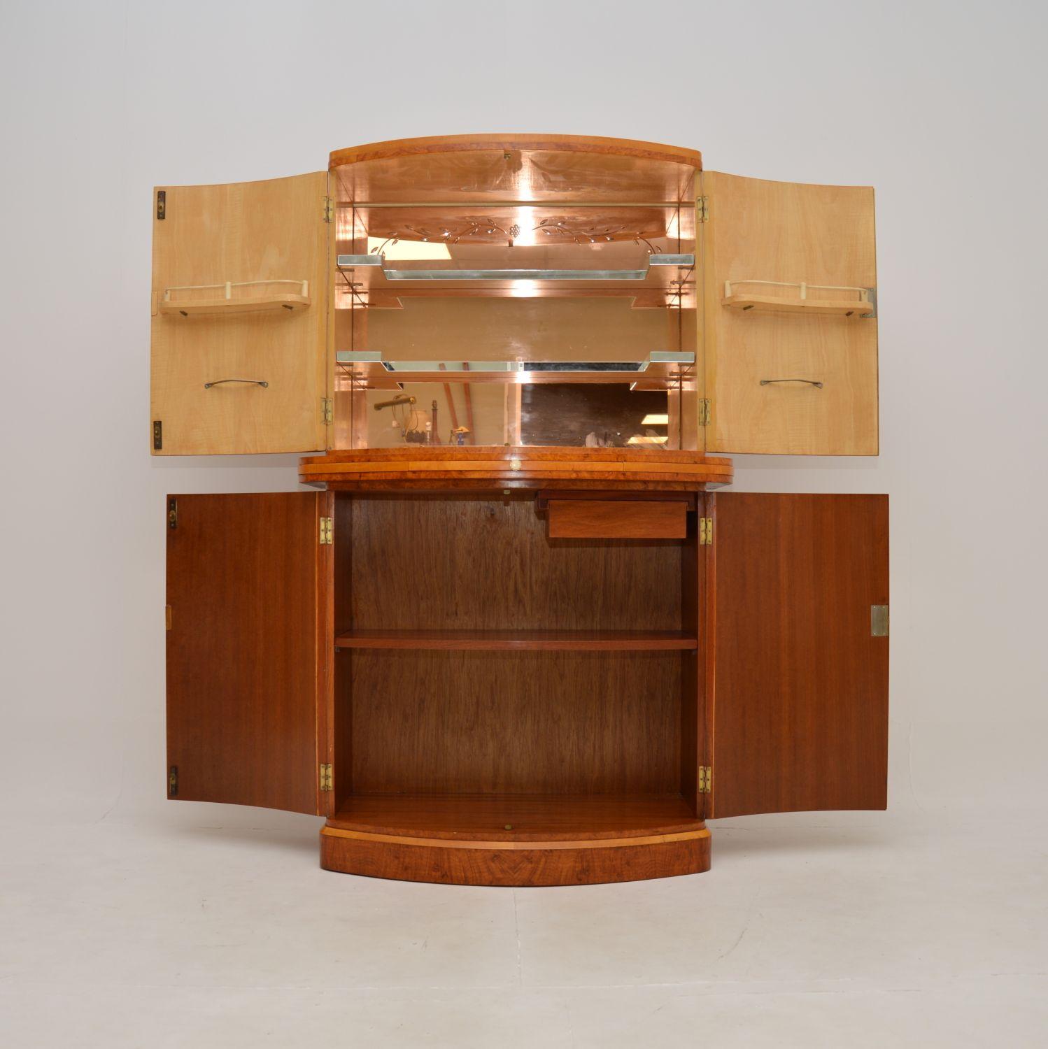 An absolutely magnificent Art Deco burr walnut cocktail cabinet by Epstein. This was made in England, it dates from the 1920-30’s.

It is of the utmost quality, this is one of the finest examples of an Art Deco drinks cabinet you could possibly