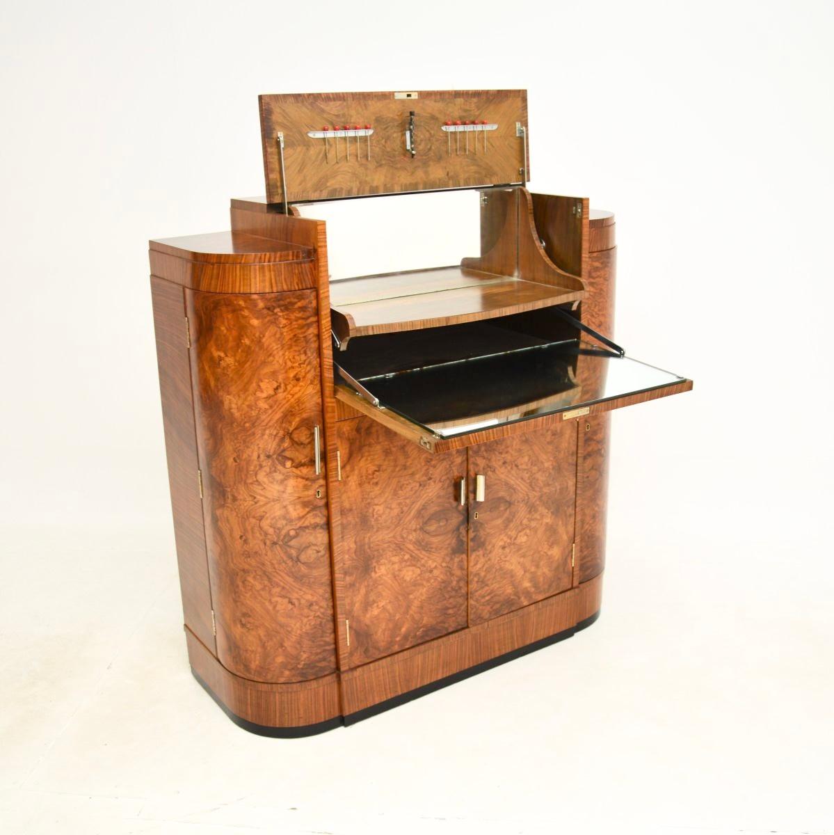 An absolutely stunning Art Deco burr walnut cocktail drinks cabinet by Maple and Co. This was made in England, it dates from the 1920-30’s.

The quality is outstanding, this is extremely well made, it has a very useful and clever design. The main