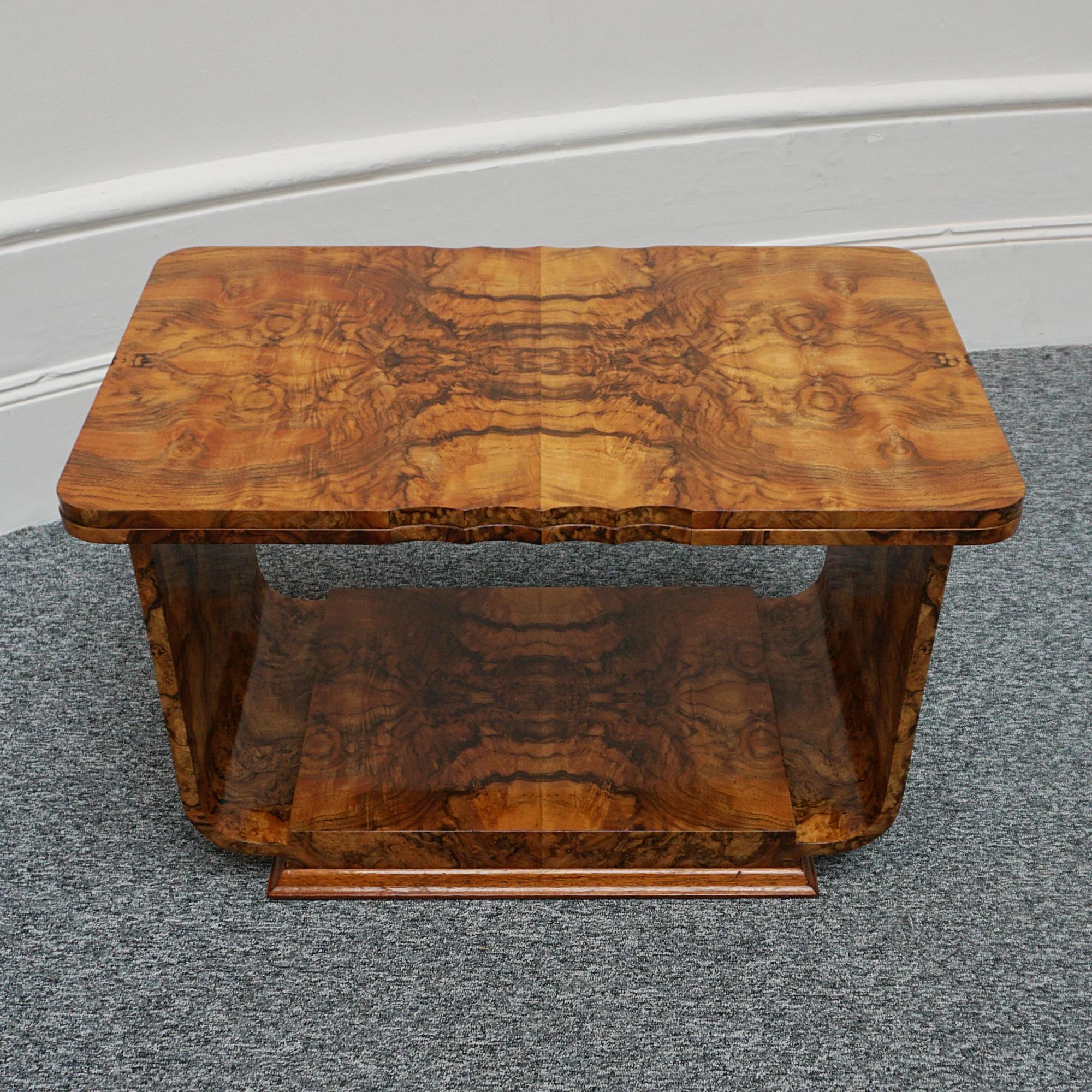 An Art Deco coffee table. Burr walnut veneered on solid mahogany with beveled edge over a U-shaped base. Excellent condition. 

Item Number: 2703243

All of our furniture is extensively polished and restored where necessary to the highest standards.