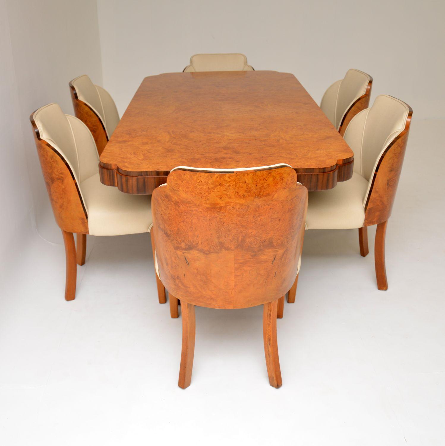 A stunning original Art Deco period walnut dining suite by Epstein. This consists of six amazing cloud back dining chairs, and a twin pedestal dining table. This is all made from stunning burr walnut, the dining table also has darker figured walnut