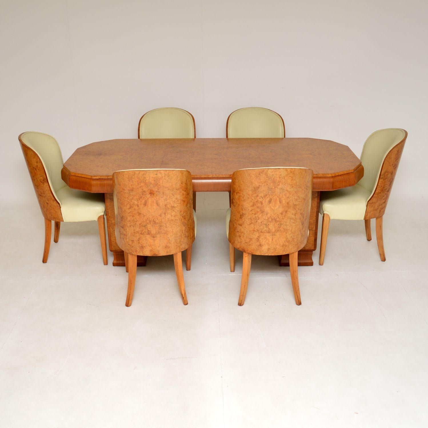A stunning original Art Deco period cloud back dining suite in burr walnut by Harry & Lou Epstein. This was made in England, it dates from the 1930’s.
It is a slightly unusual model, and is of particularly fine quality. The twin pedestal dining