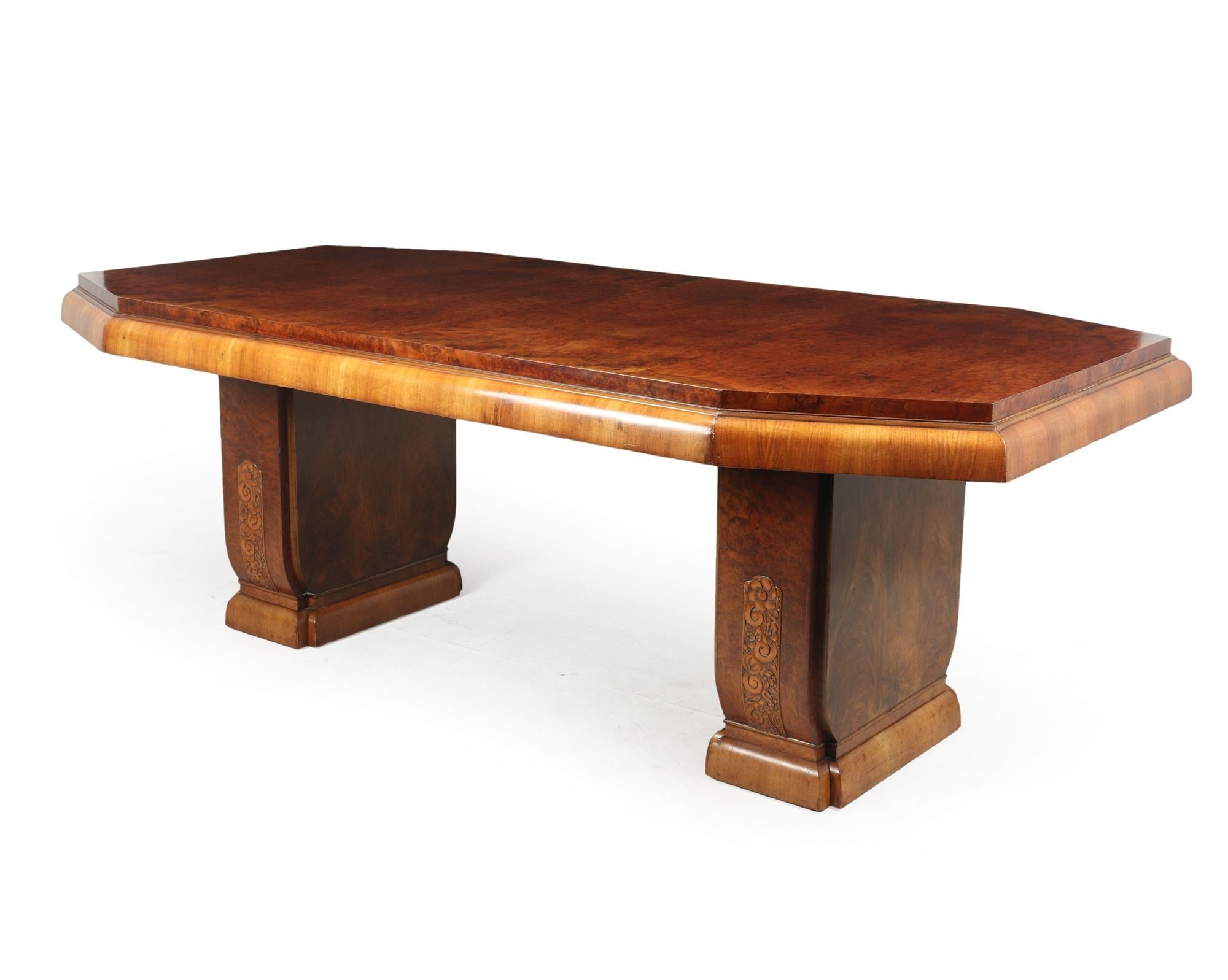 A large Art Deco dining table on a twin pedestal base in burr walnut with lovely figuring, carved motifs to the pedestal the table has been fully polished and is in excellent condition throughout

Age: 1930

Style: Art Deco

Material: Burr