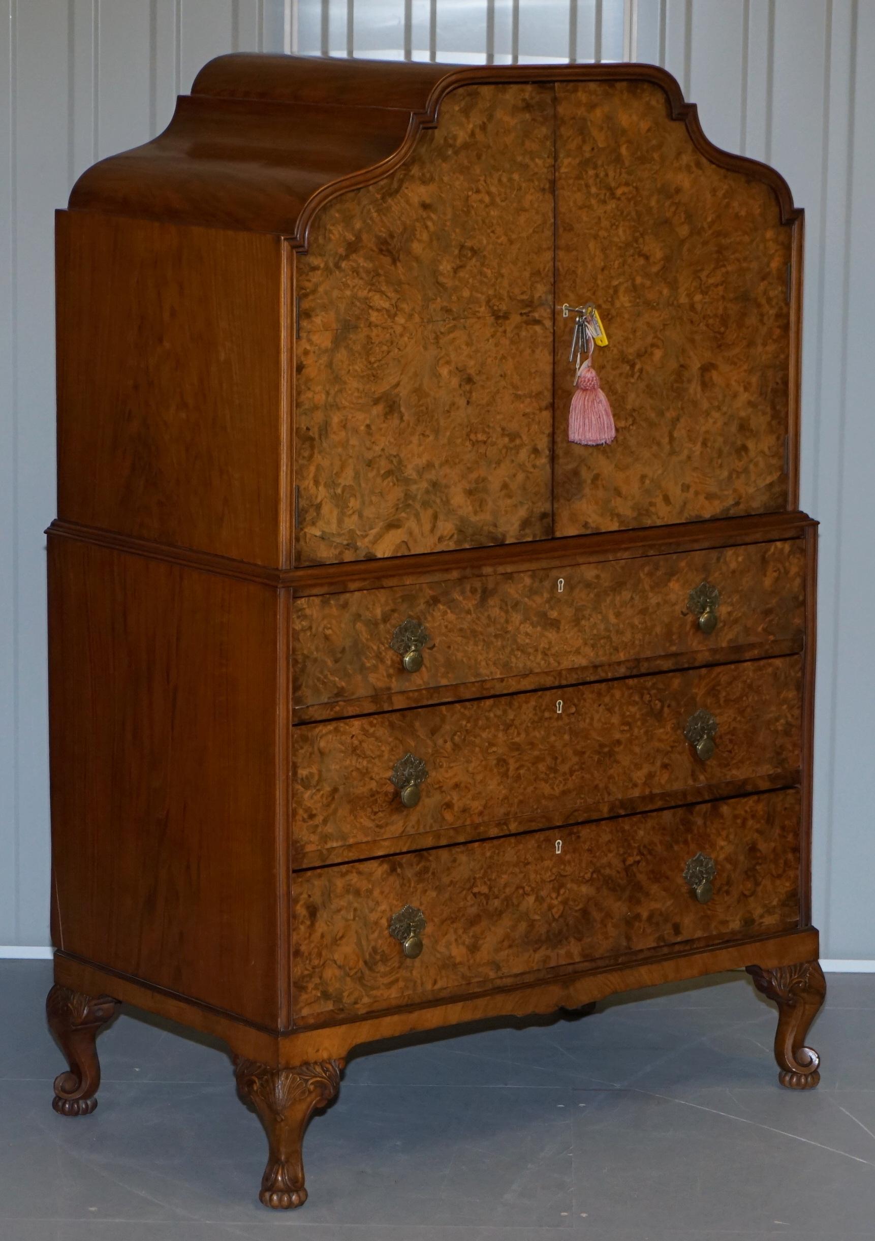 We are delighted to offer for sale this absolutely stunning original Art Deco circa 1920 Burr Walnut drinks cabinet with drawers

A very good looking and decorative piece of furniture. The top section has a large cupboard for glasses and bottles,