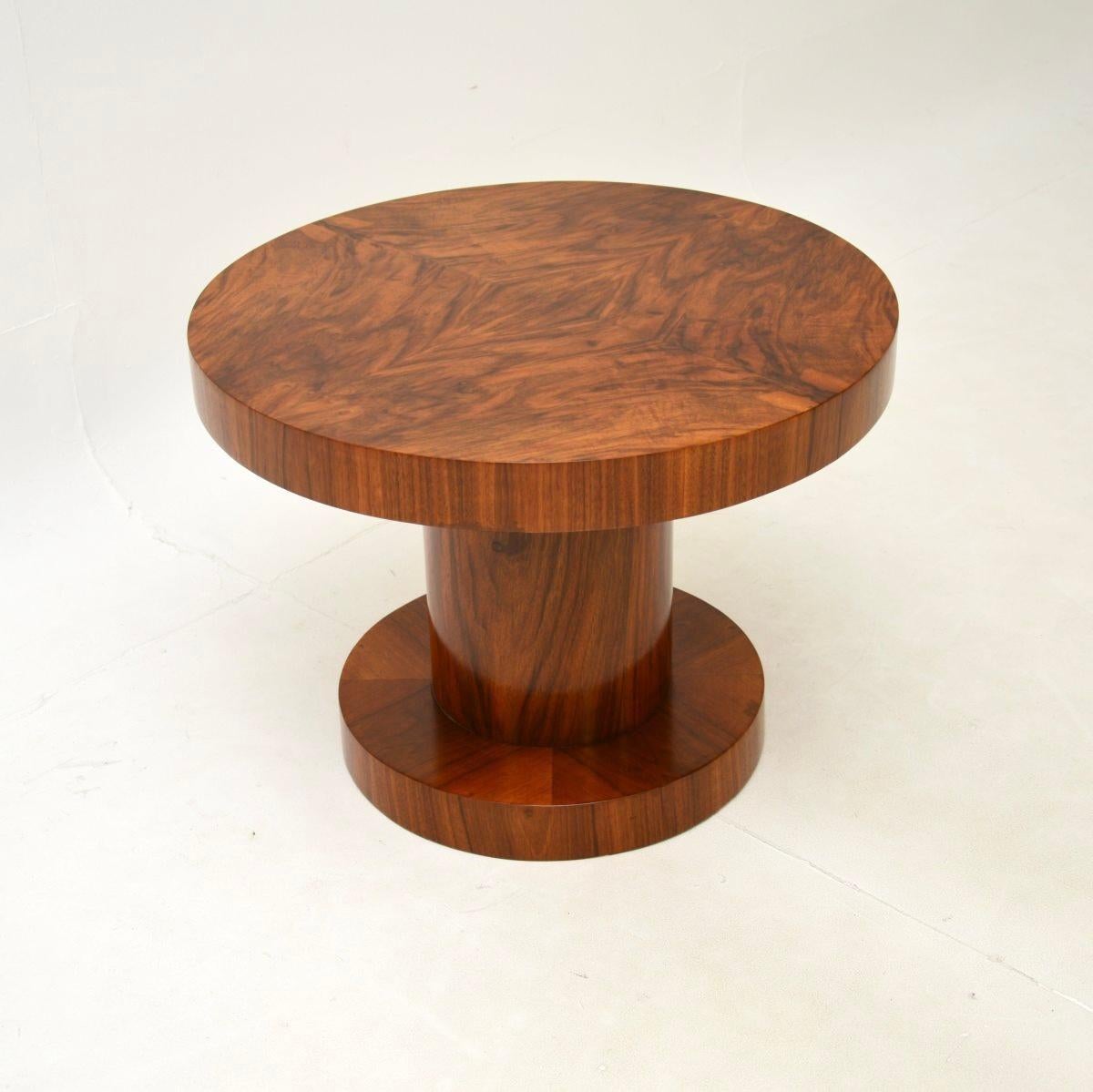 A stunning Art Deco burr walnut occasional side table, made in England and dating from the 1930’s.

It is of superb quality with a stylish and bold design. The circular top has a thick edge, it stands on a thick column base that stands on a circular