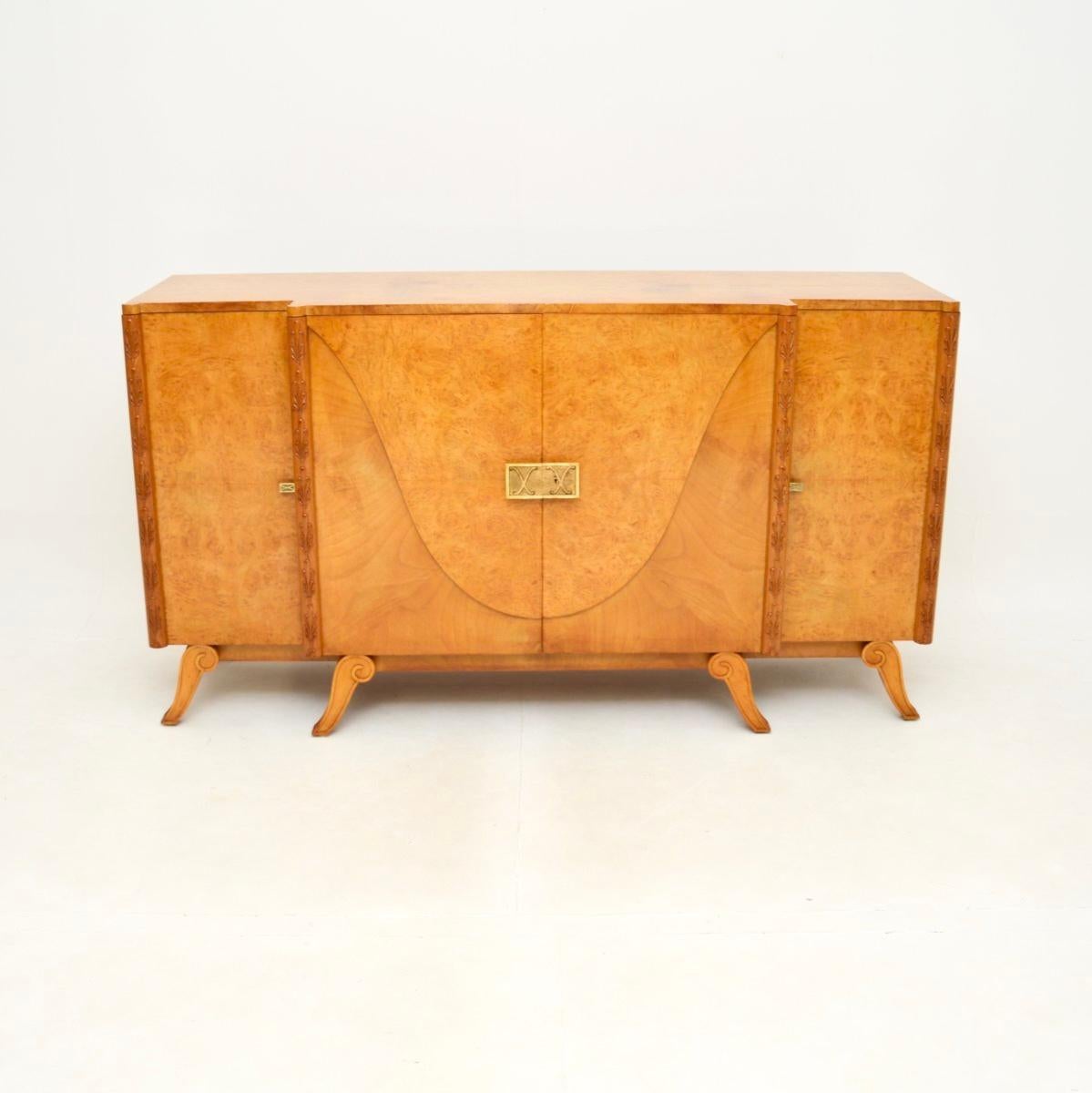 A magnificent Art Deco burr walnut sideboard by Hille. This was made in England, it dates from the 1920’s.

The quality is outstanding, this is incredibly well made and is a substantial size. There are stunning burr walnut grain patterns, it stands