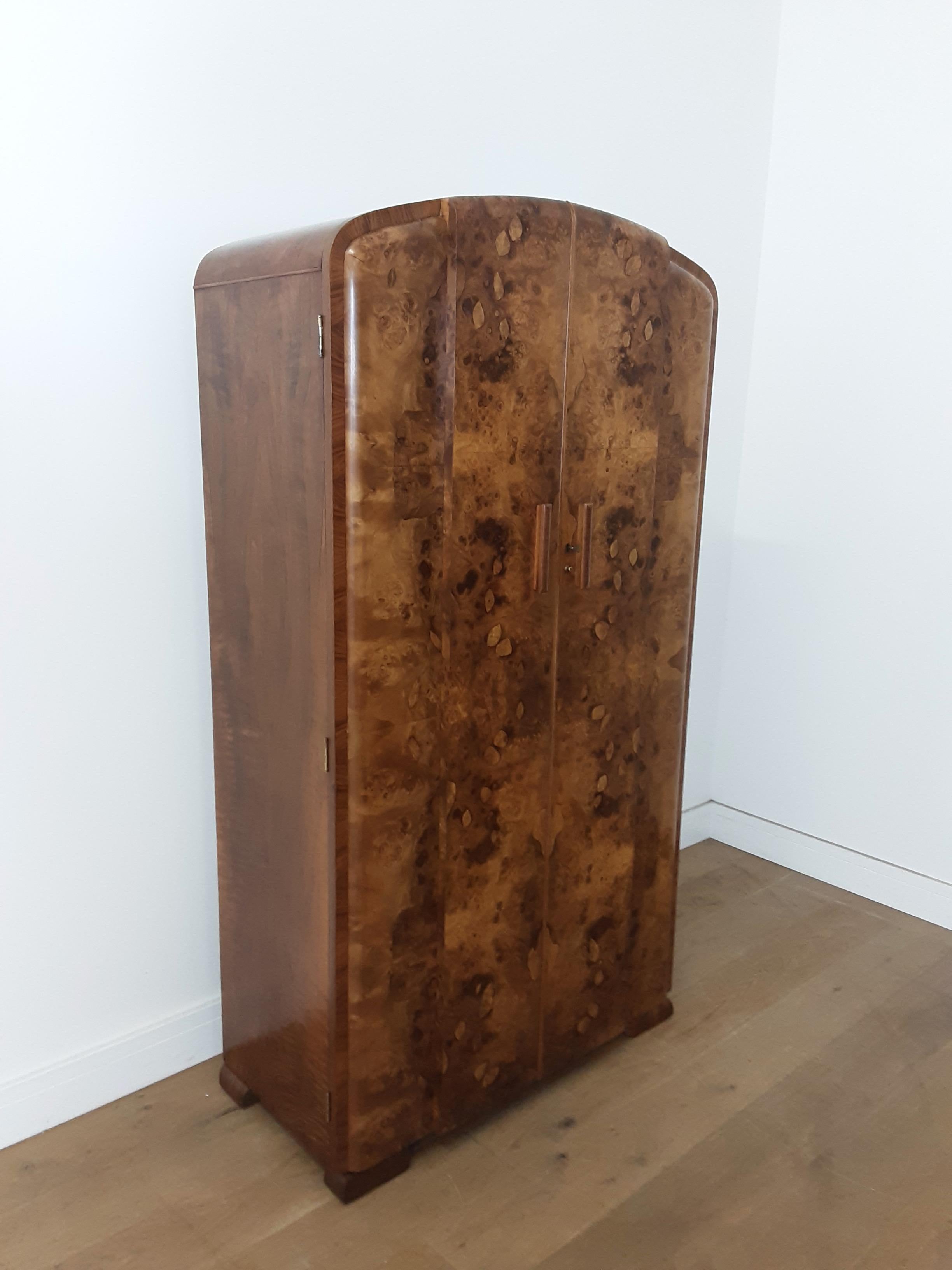 Art deco tall boy in a stunning figured walnut by Grange furnishing stores London.
internally fitted with pull out hanging rail, top shelf and compartmented shelving to the right.
Tall boy is 167 cm h 92 cm w 44 cm d 41 cm d at the sides
British