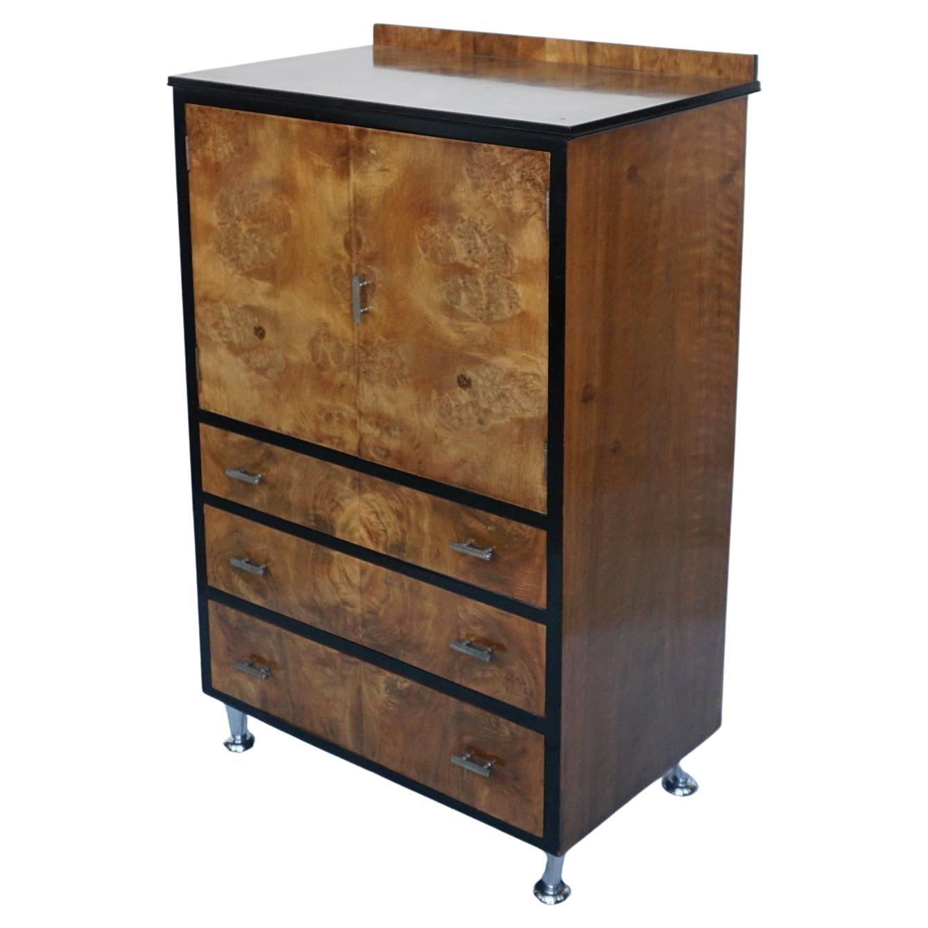 An Art Deco Tallboy Cabinet. Burr and Figured Walnut veneered with ebonised banding and original metal handles. 

Dimensions: H 120cm W 76cm D 49cm 

Origin: English

Date: Circa 1935

Item Number: 2704224

All of our furniture is