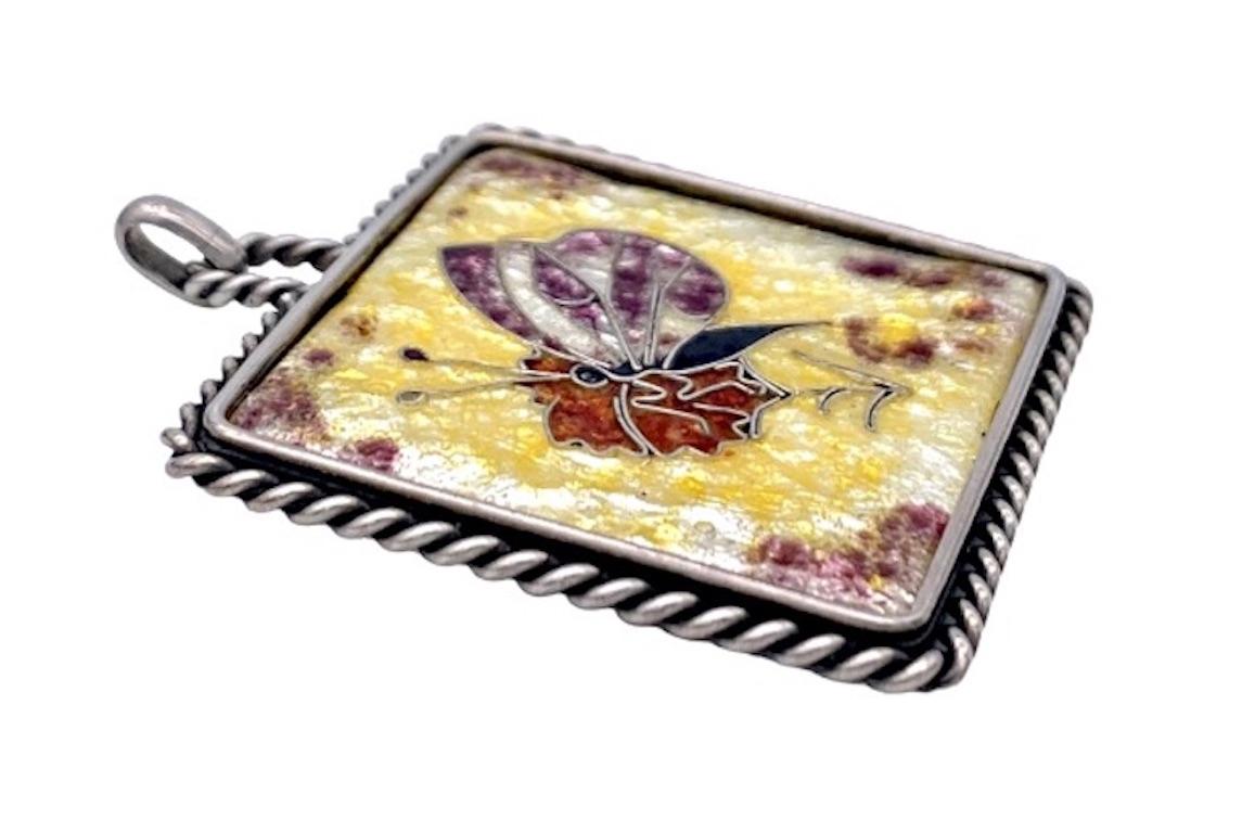 This unusual Art Deco pendant is beautifully enamelled in cloisonné tecnique. The artist has used a wonderful range of colours..The particular beauty about this piece of jewellery is that the outline of the butterfly hasbeen cut out of the silver