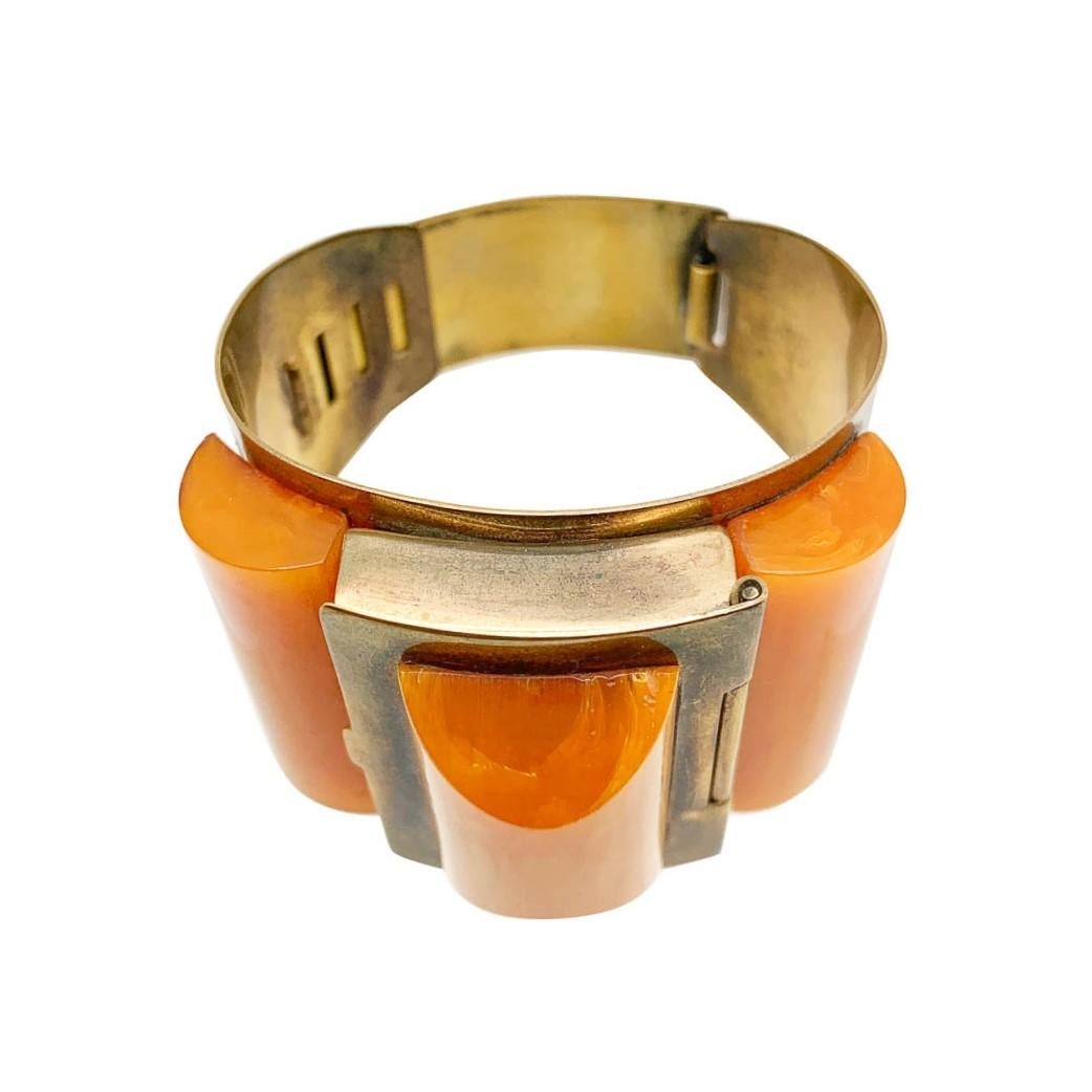 An outstanding piece of 1930s Art Deco wearable art. Stylish and innovative. This original art deco wrist compact features a broad cuff set with three large and beautifully cut geometric  marbled butterscotch bakelite pieces; the centre cleverly