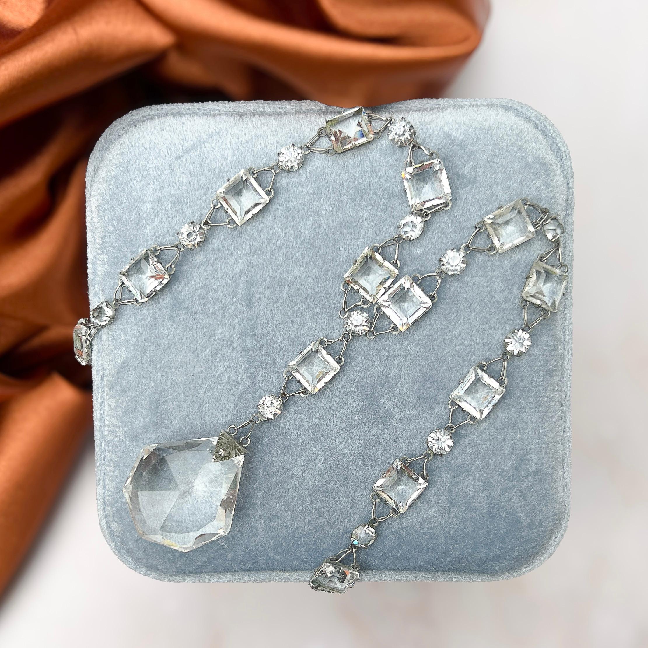 This elegant necklace was created in c.1920. 

Condition Report:
Very Good - A tiny chip to one corner of the crystal pendant. This is only apparent upon close inspection with a magnifying glass and does not detract from the appeal of the piece.