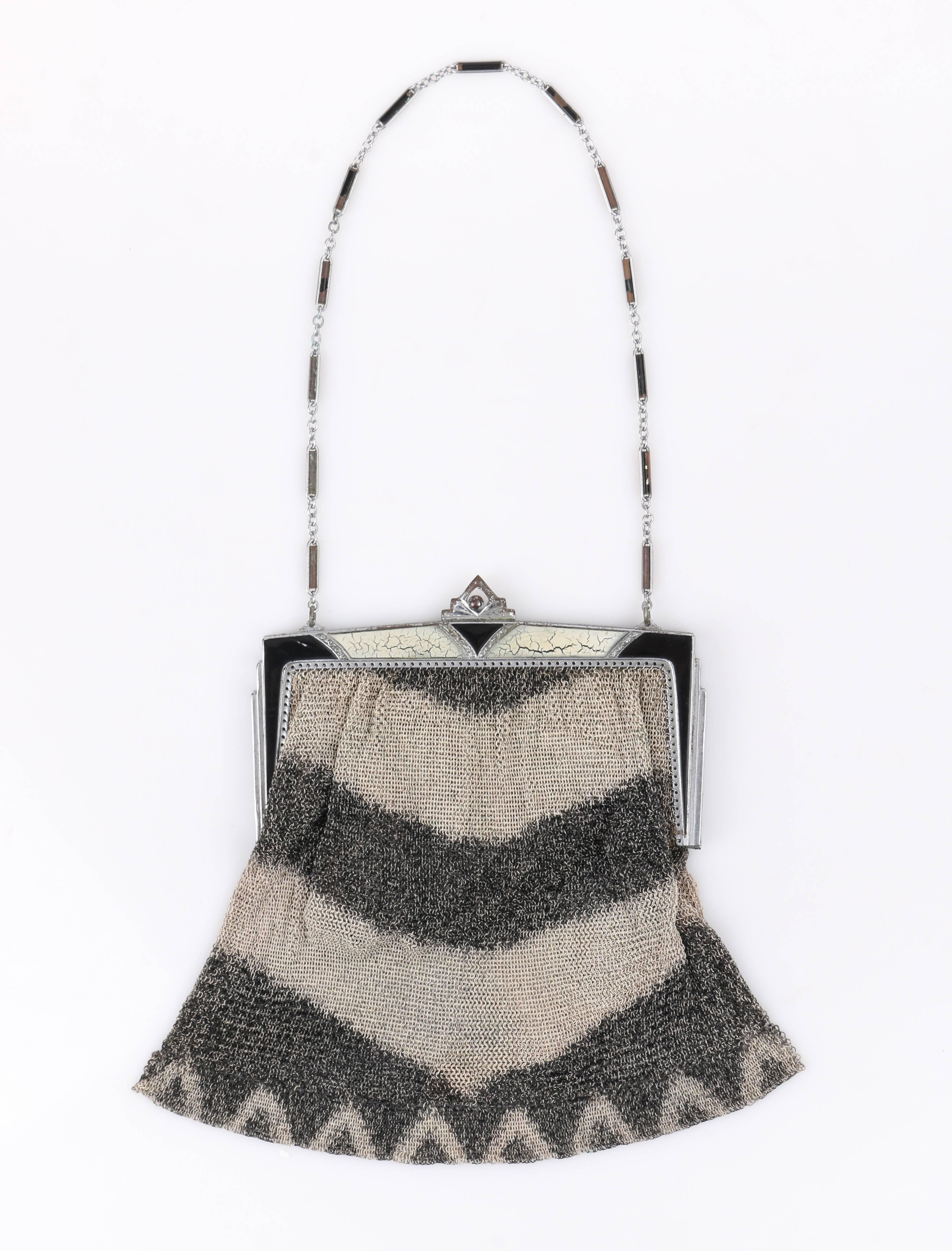 Vintage Art Deco c.1920's gray metal mesh enamel frame top flapper evening purse. Taupe and charcoal gray chevron patterned metal mesh body. Silver-toned metal frame top with black and beige enamel and carved filigree detail. Pointed art deco kiss