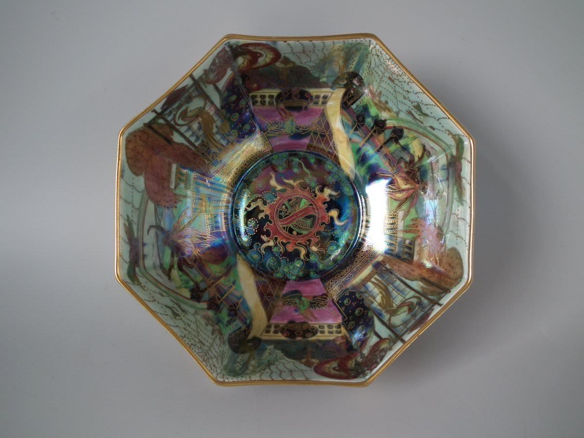 Wedgwood fairyland lustre octagonal bowl, the exterior decorated in 'Gargoyles' pattern, on night-time ground. This pattern features Fairies, elves, imps, firbolgs and birds dancing amongst various landscapes and scenes. And pillar archways with