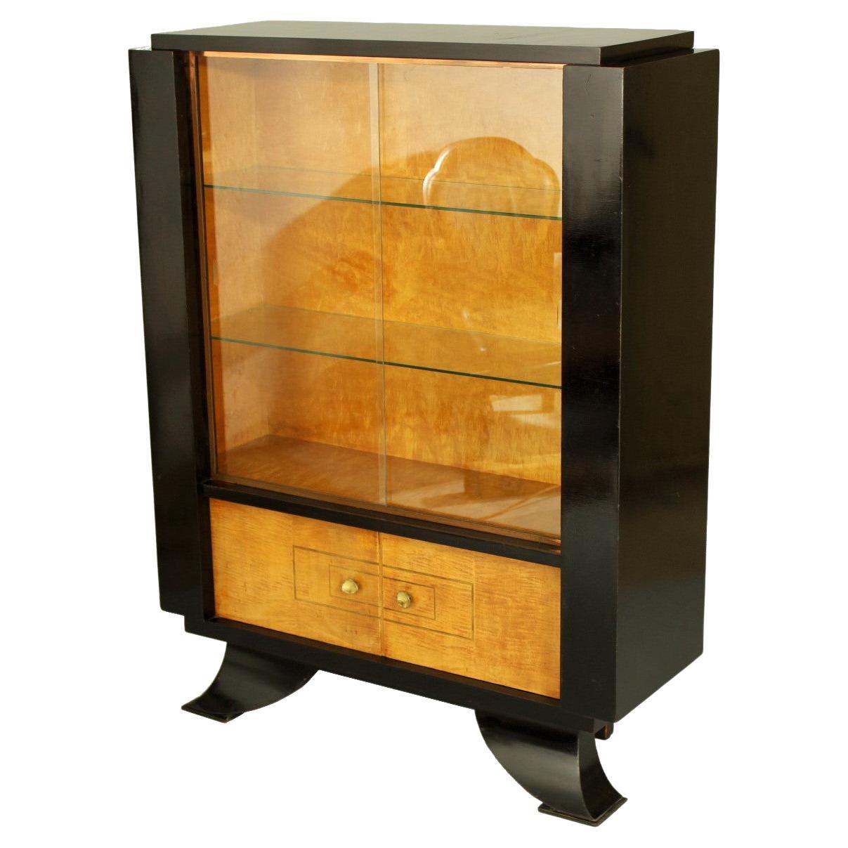 Early Art Deco cabinet from the 1920s. This cabinet is very well made and is in its original condition with some scratches and small chips, please see the photos. Material is ebonized veneer, mahogany veneer and glass.