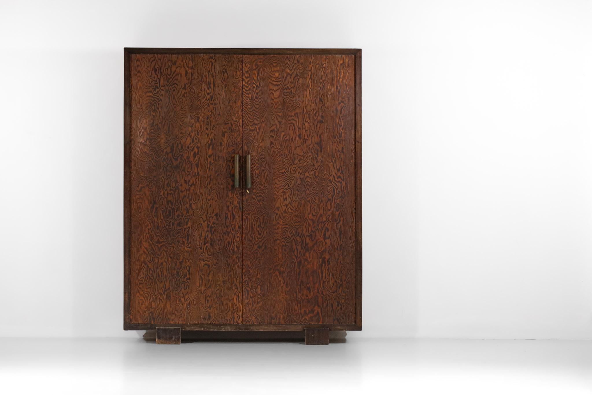 Imposing Art Deco cabinet from the 50's attributed to the French designer André Sornay. Structure in solid and veneered Oregon pine, with two beautiful solid brass handles. This armoire has two hinged doors opening on one side to a wardrobe and on
